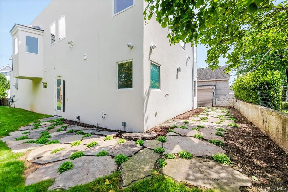 Back of house with stucco siding and crawl space Back of house with stucco siding and crawl space