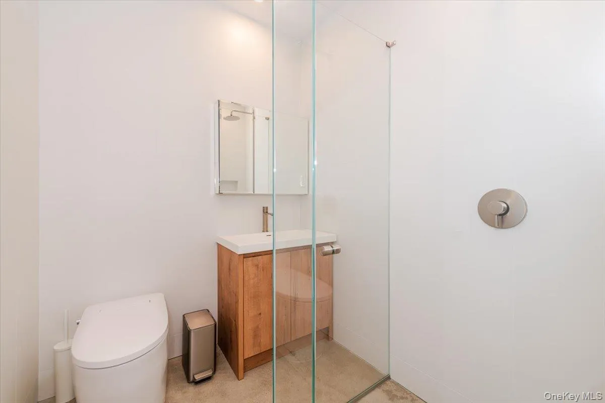 Bathroom featuring vanity and an enclosed shower Bathroom featuring vanity and an enclosed shower