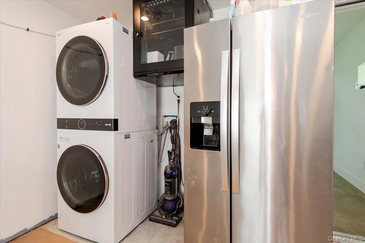 Laundry area with stacked washer / drying machine Laundry area with stacked washer / drying machine