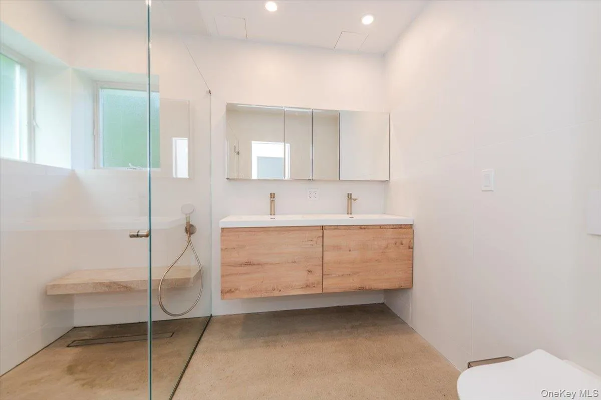 Bathroom with double vanity, walk in shower, plenty of natural light, and recessed lighting Bathroom with double vanity, walk in shower, plenty of natural light, and recessed lighting