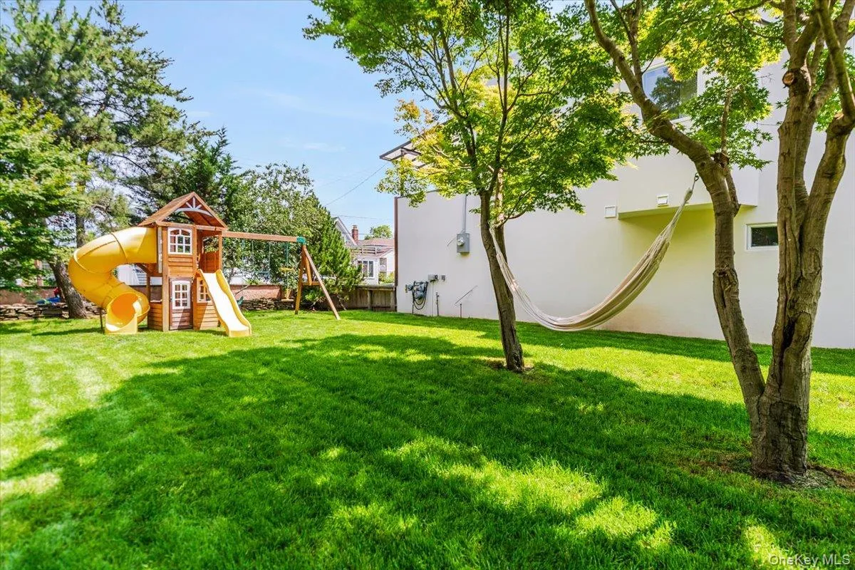 View of green lawn with a playground View of green lawn with a playground