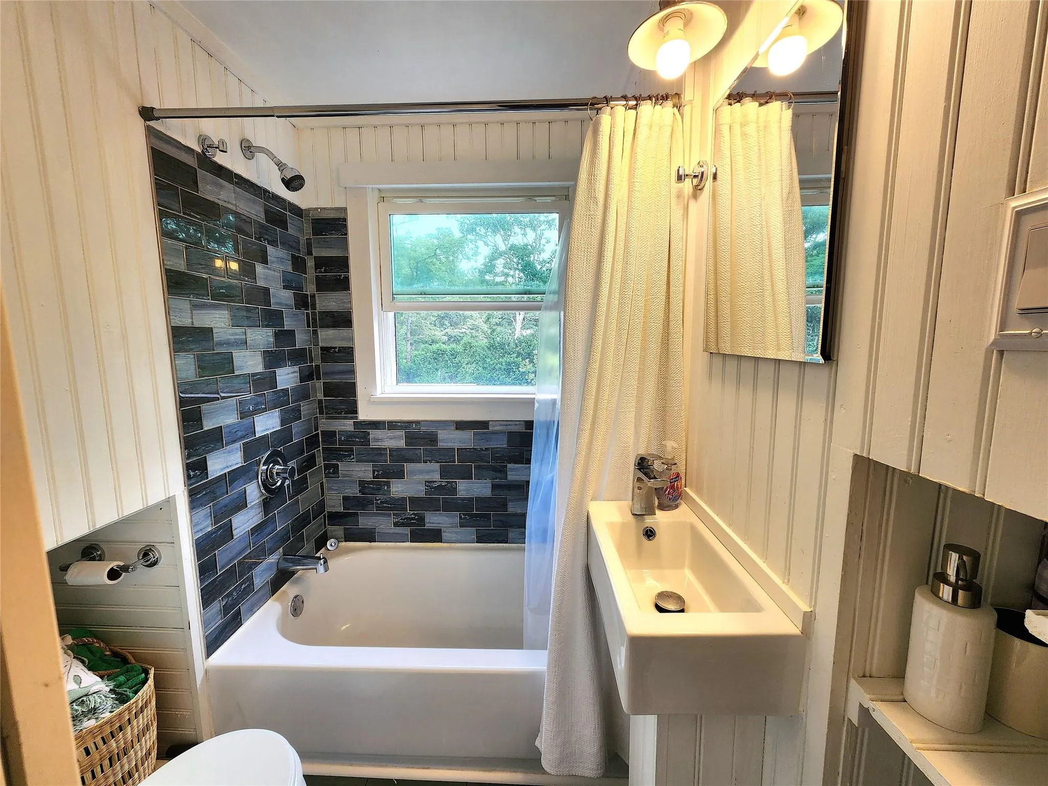 Bathroom with shower / bath combo with shower curtain and toilet Bathroom with shower / bath combo with shower curtain and toilet