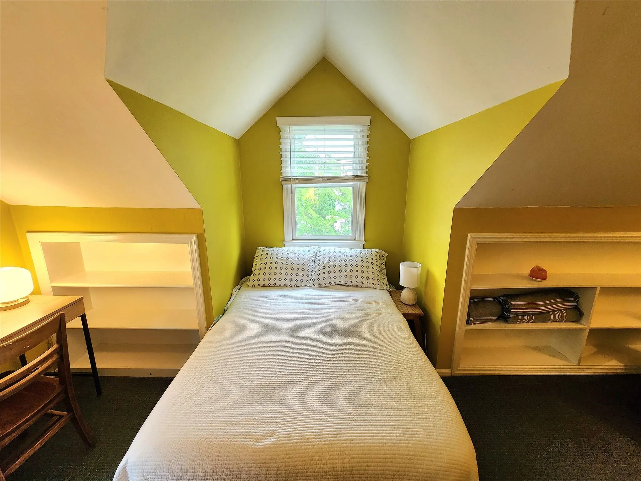 Bedroom featuring dark colored carpet and lofted ceiling Bedroom featuring dark colored carpet and lofted ceiling