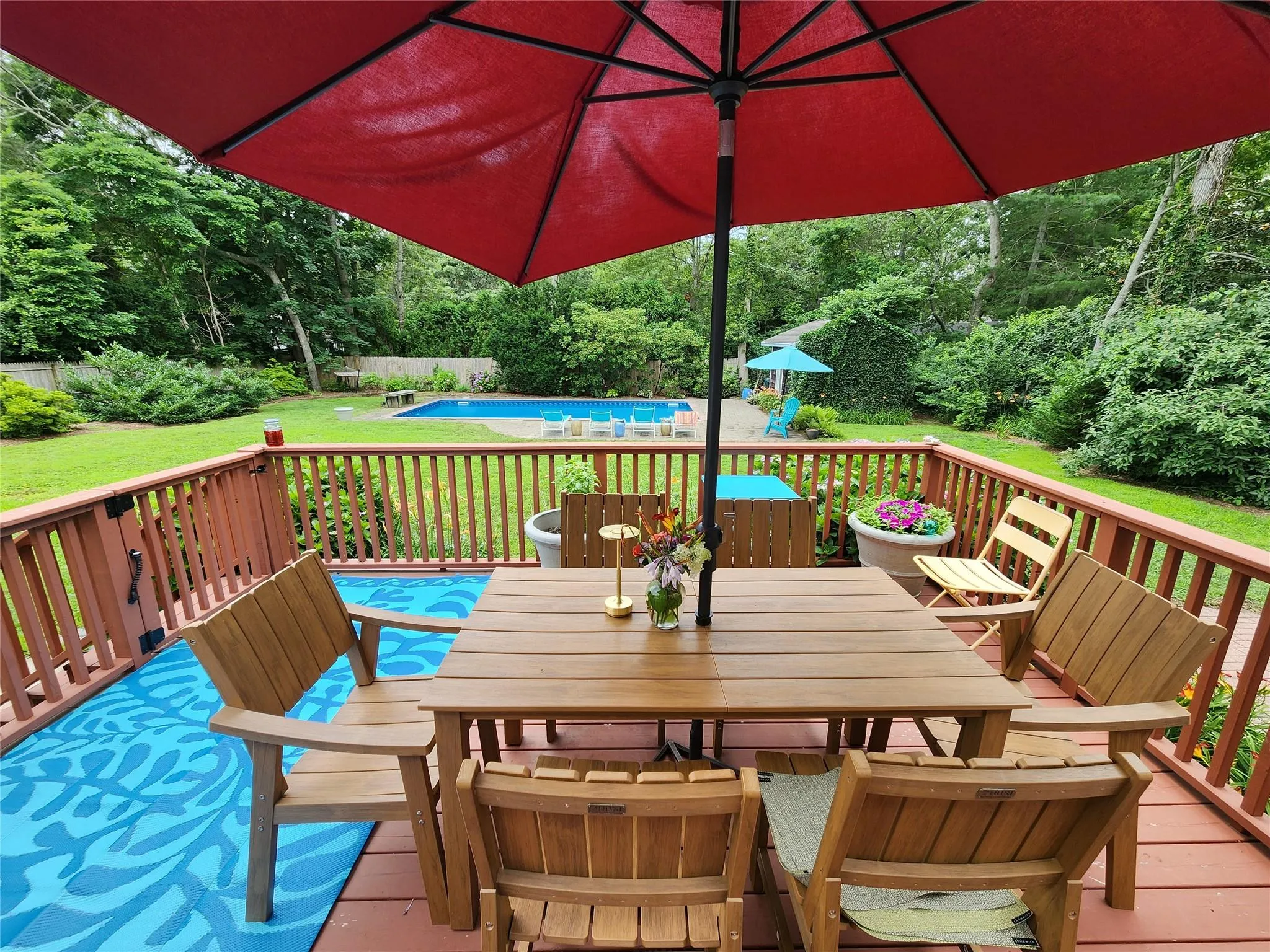 Wooden terrace with outdoor dining space and a lawn Wooden terrace with outdoor dining space and a lawn