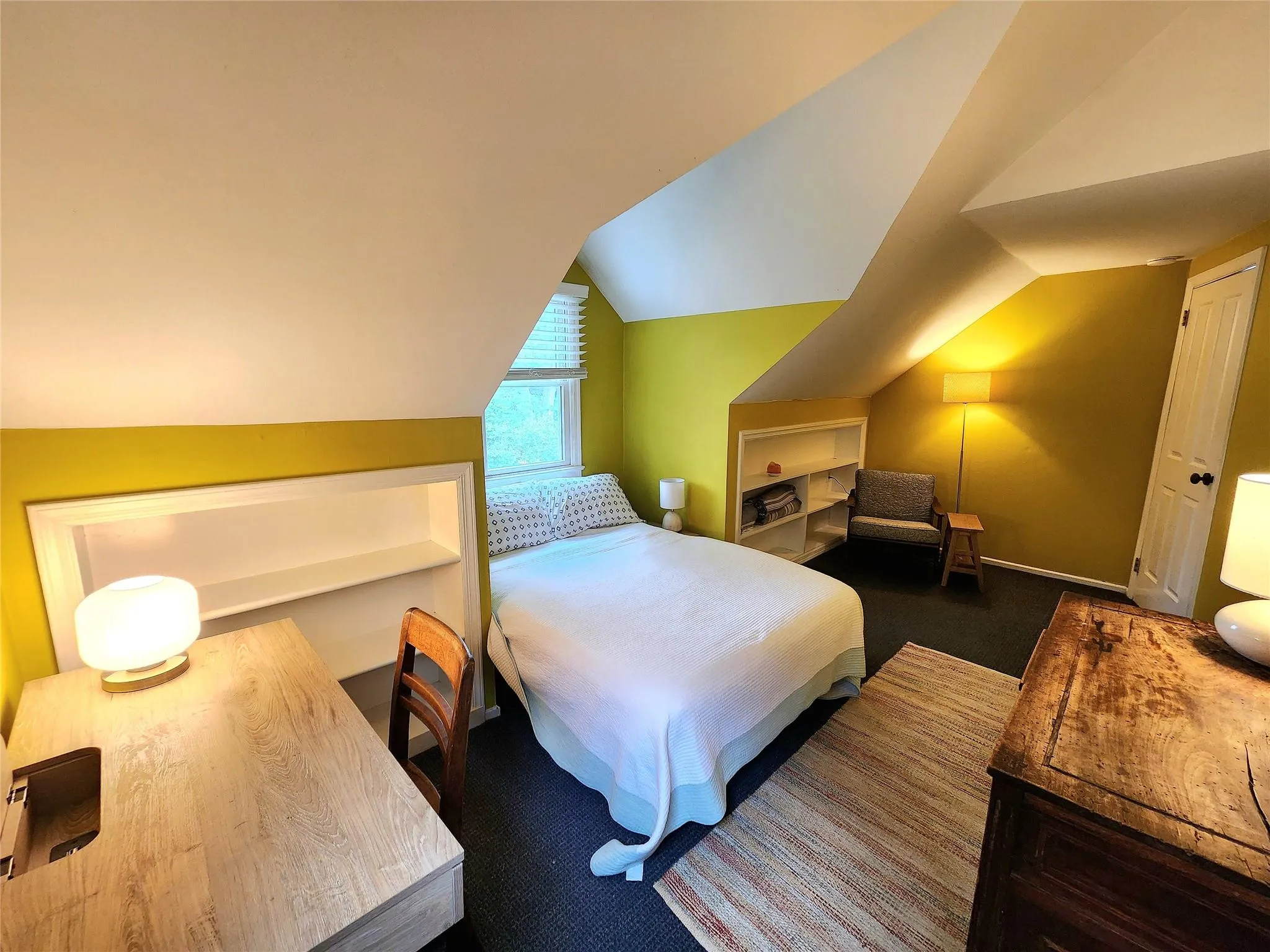 Bedroom featuring vaulted ceiling and carpet flooring Bedroom featuring vaulted ceiling and carpet flooring