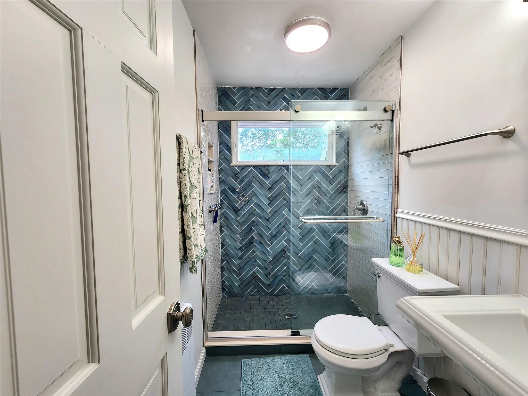 Bathroom with tile patterned floors and a shower stall Bathroom with tile patterned floors and a shower stall