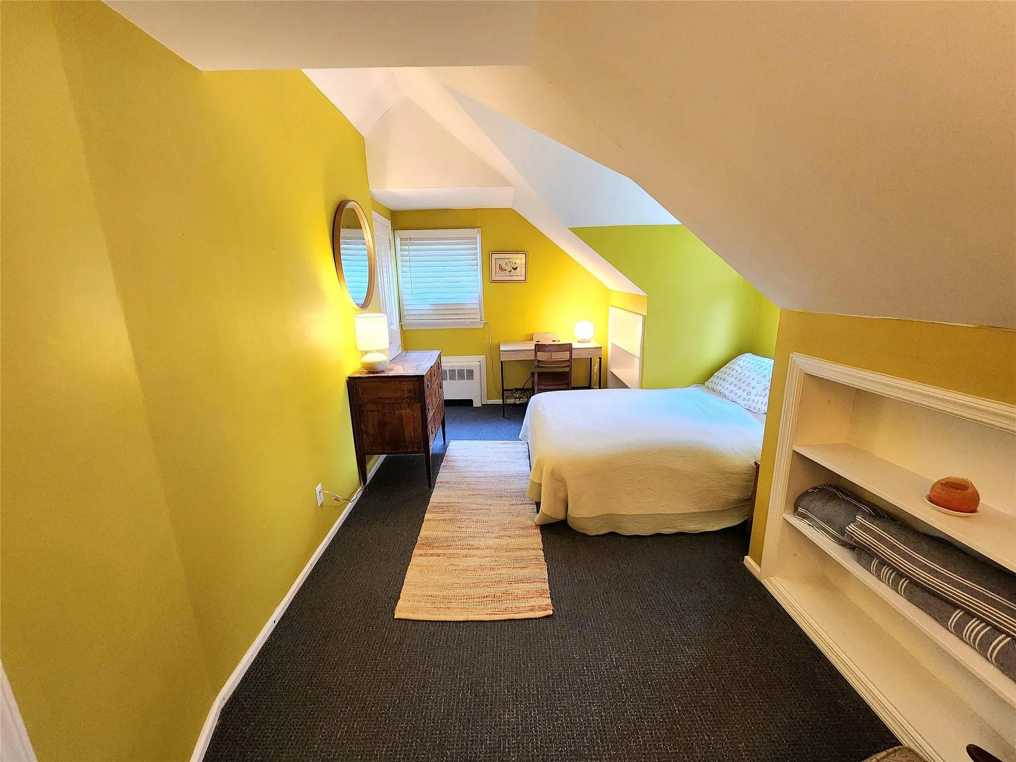 Bedroom featuring carpet flooring, radiator, and lofted ceiling Bedroom featuring carpet flooring, radiator, and lofted ceiling