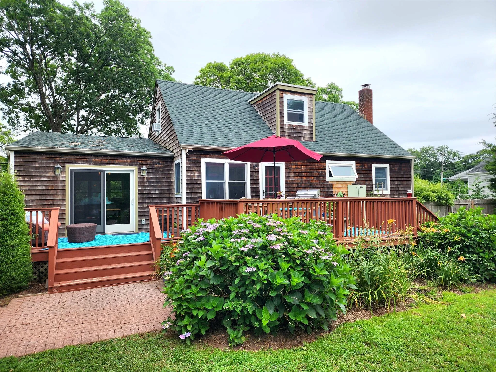 Rear view of house featuring a roof with shingles, and a deck Rear view of house featuring a roof with shingles, and a deck