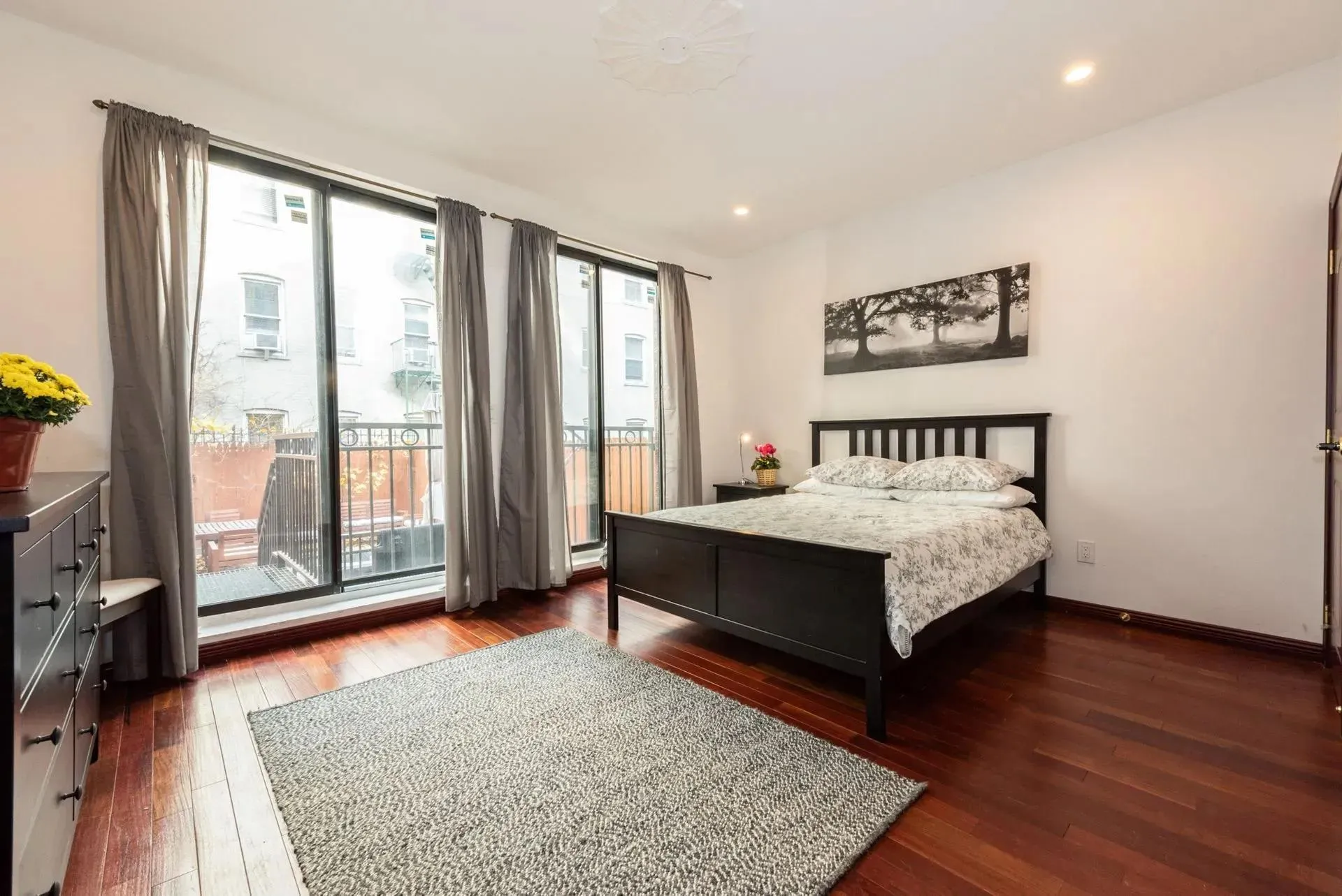 Bedroom with access to outside, hardwood / wood-style flooring, and recessed lighting Bedroom with access to outside, hardwood / wood-style flooring, and recessed lighting