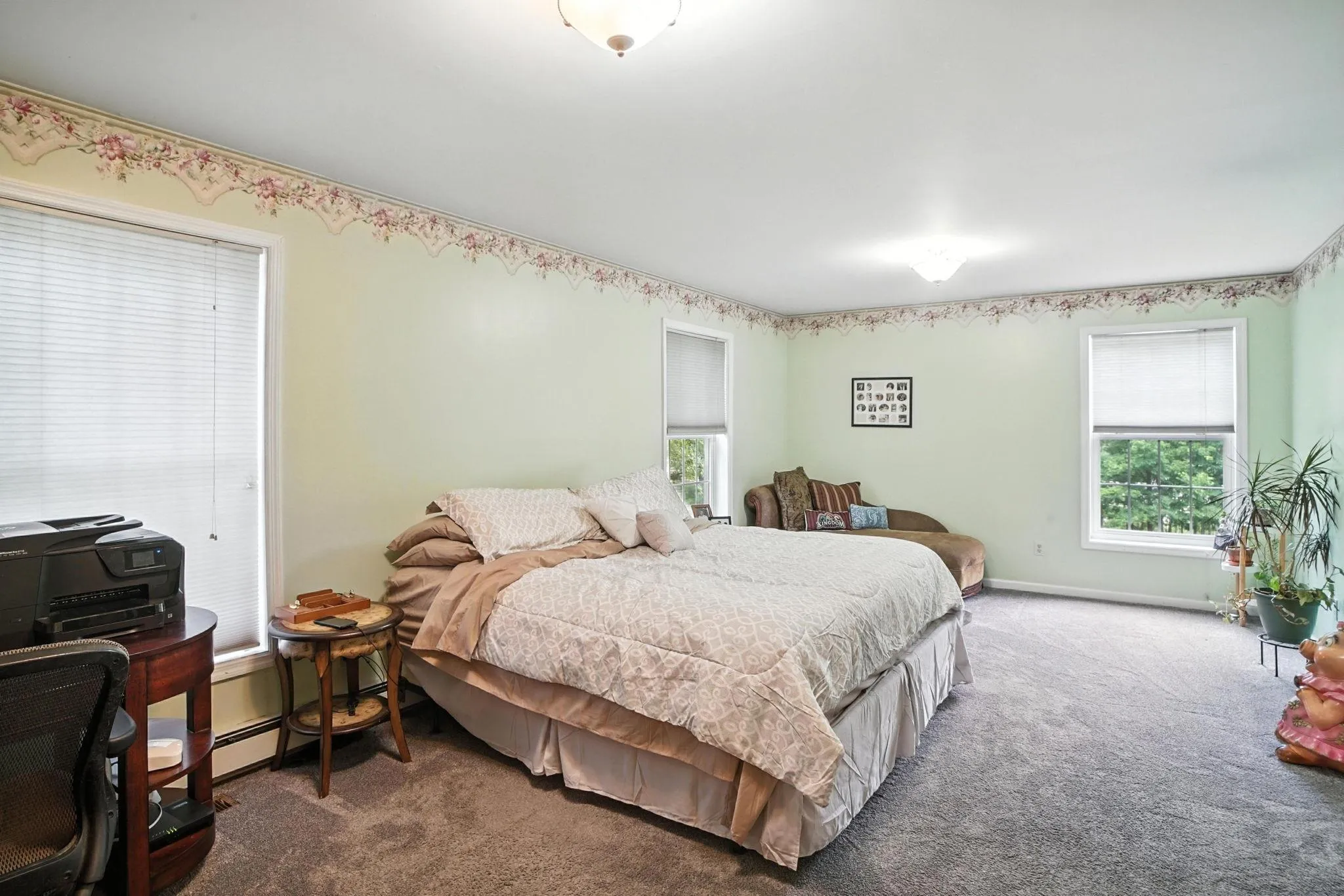 Carpeted bedroom with multiple windows Carpeted bedroom with multiple windows