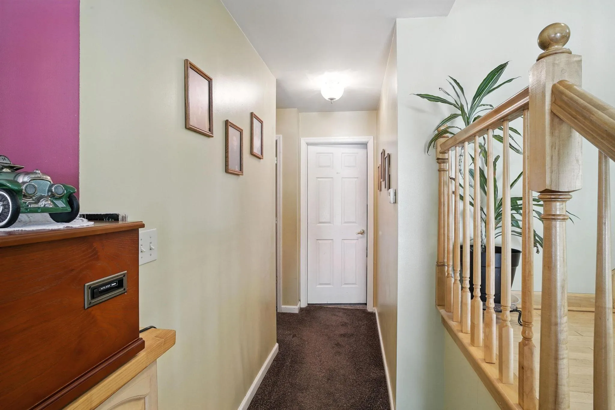Hallway with carpet flooring and baseboards Hallway with carpet flooring and baseboards