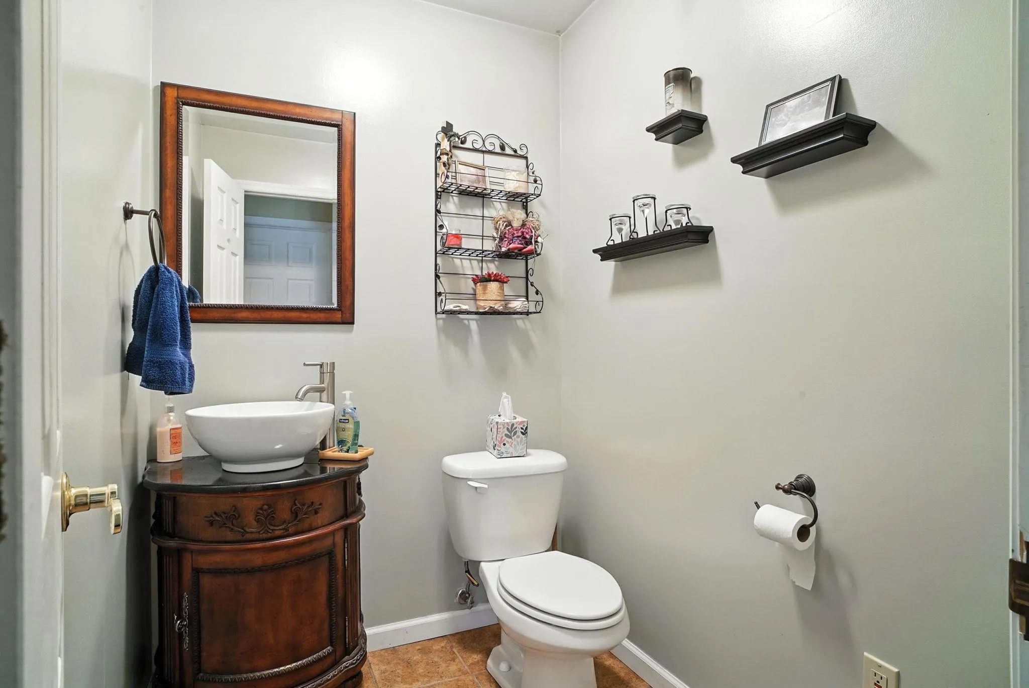 Half bath featuring vanity and tile patterned flooring Half bath featuring vanity and tile patterned flooring