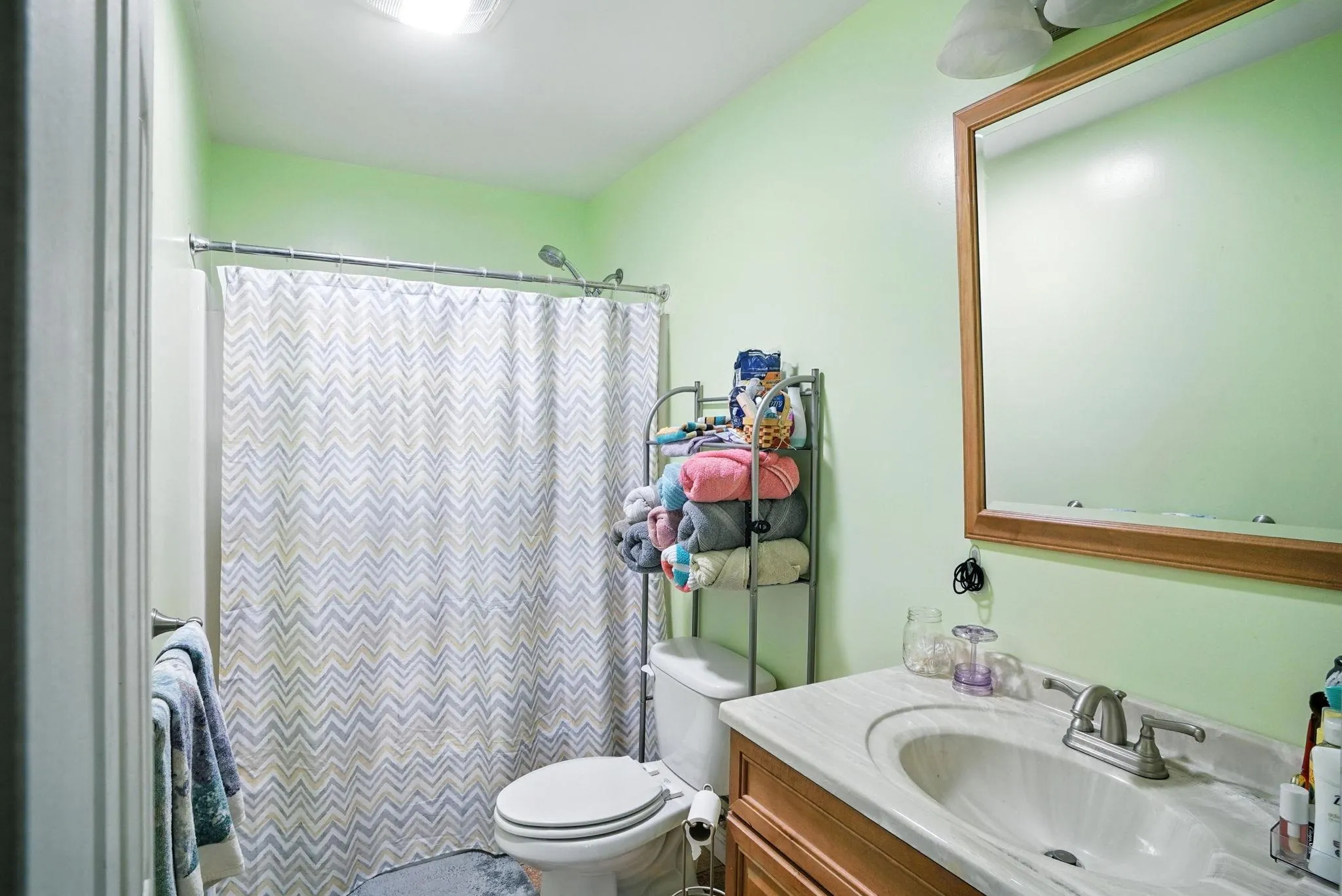 Full Bathroom in bedroom featuring vanity and a shower Full Bathroom in bedroom featuring vanity and a shower