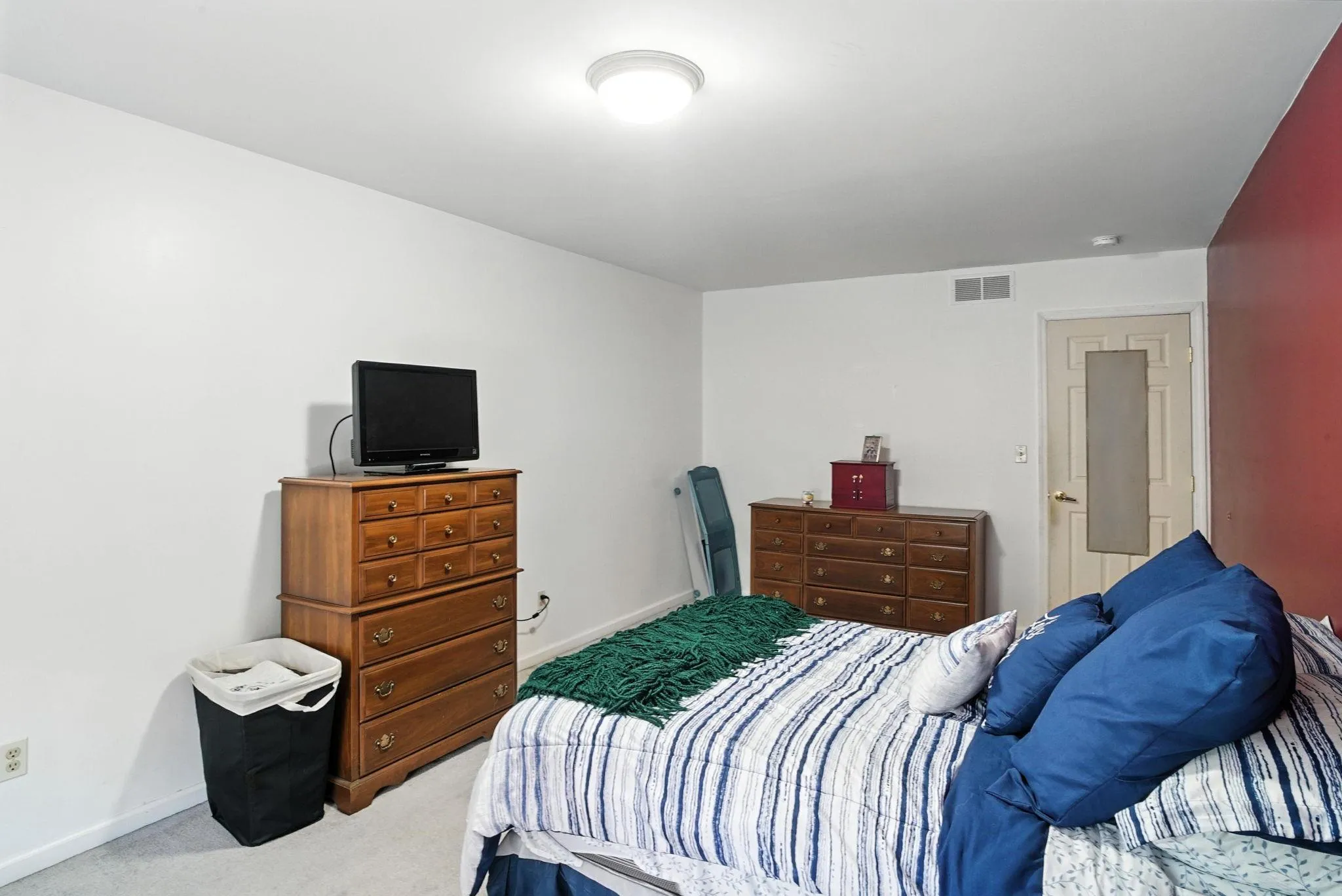 Bedroom featuring light colored carpet and baseboards Bedroom featuring light colored carpet and baseboards