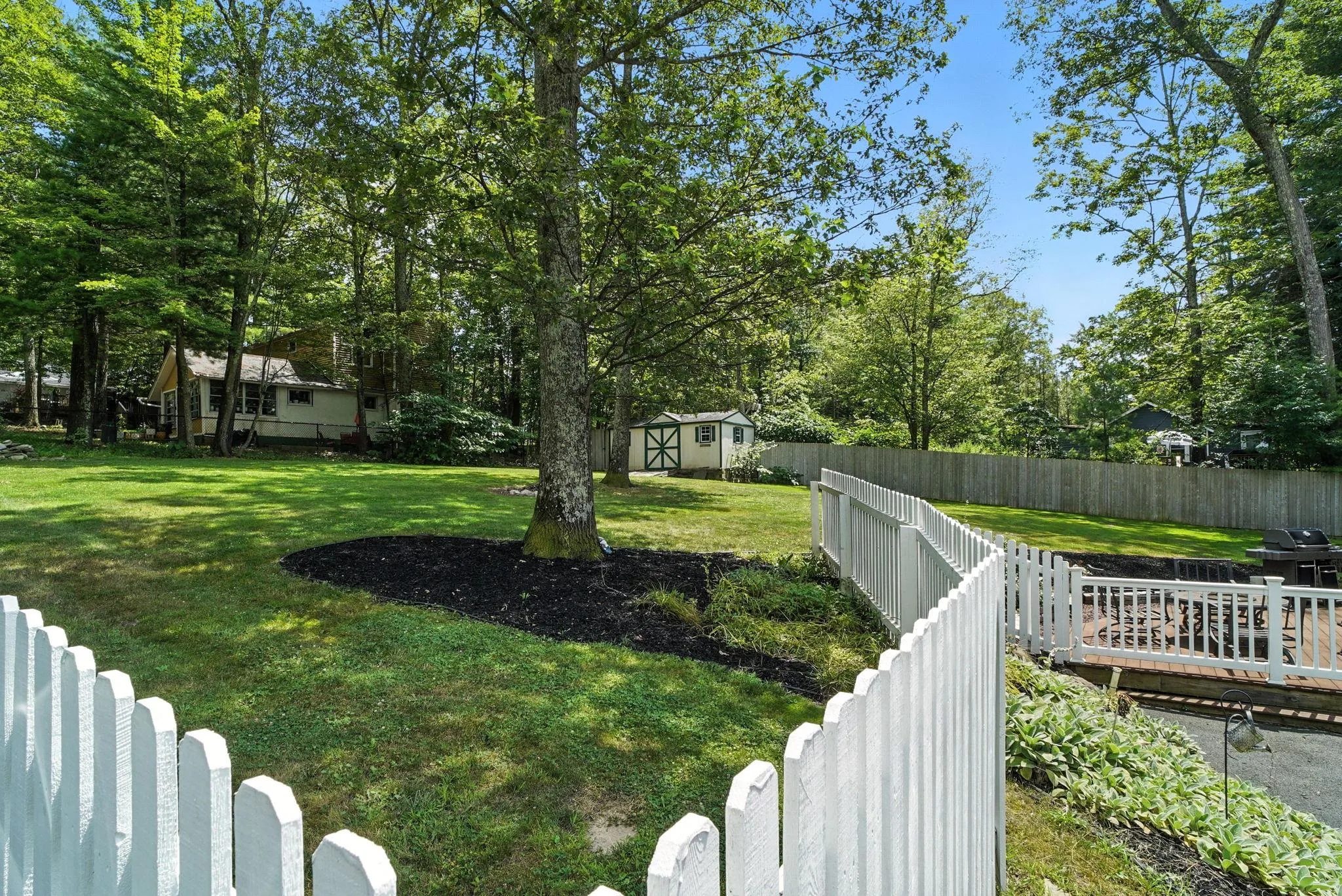 Large Fenced backyard featuring a shed and view of wooded area Large Fenced backyard featuring a shed and view of wooded area
