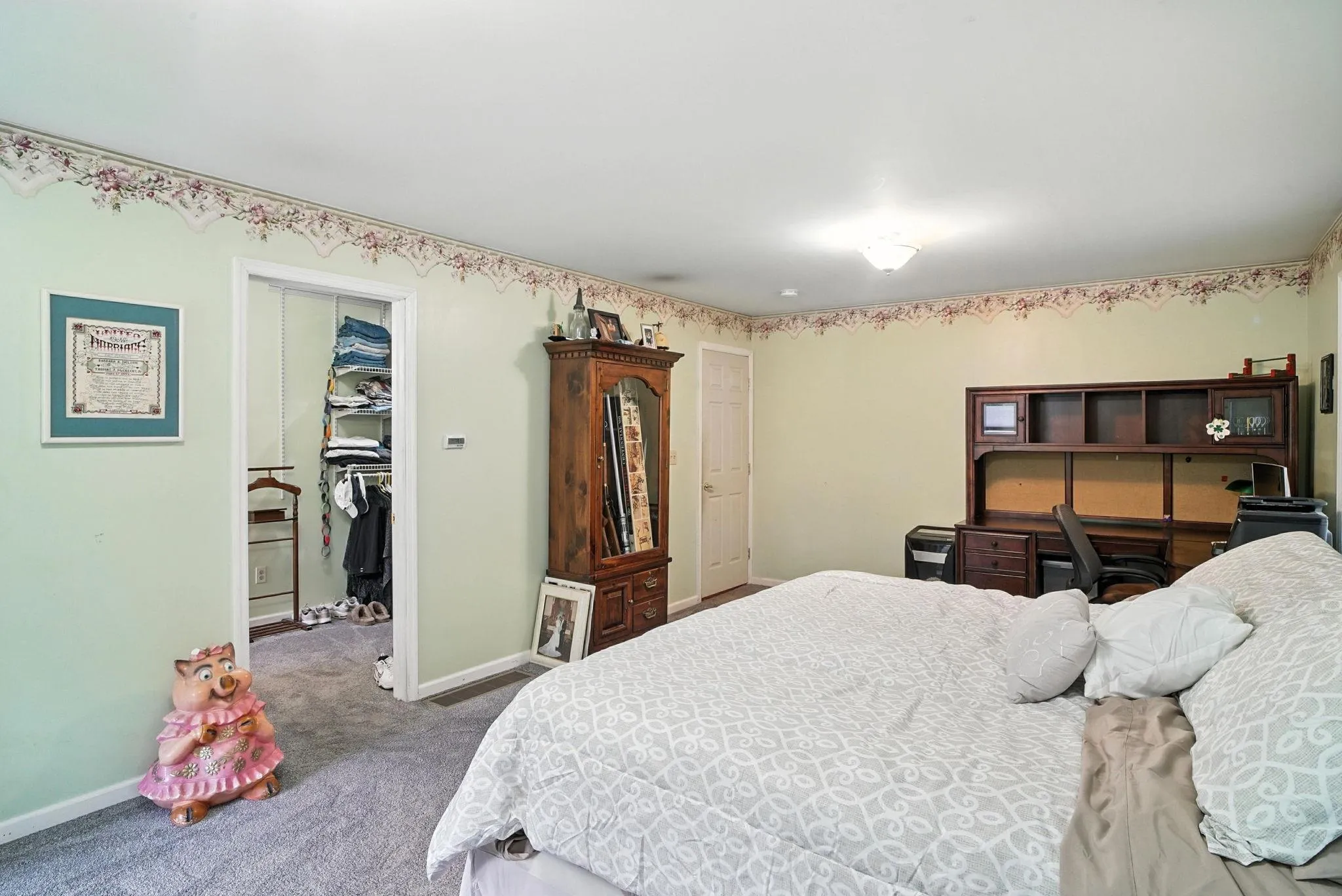 Bedroom featuring carpet flooring and a spacious closet Bedroom featuring carpet flooring and a spacious closet