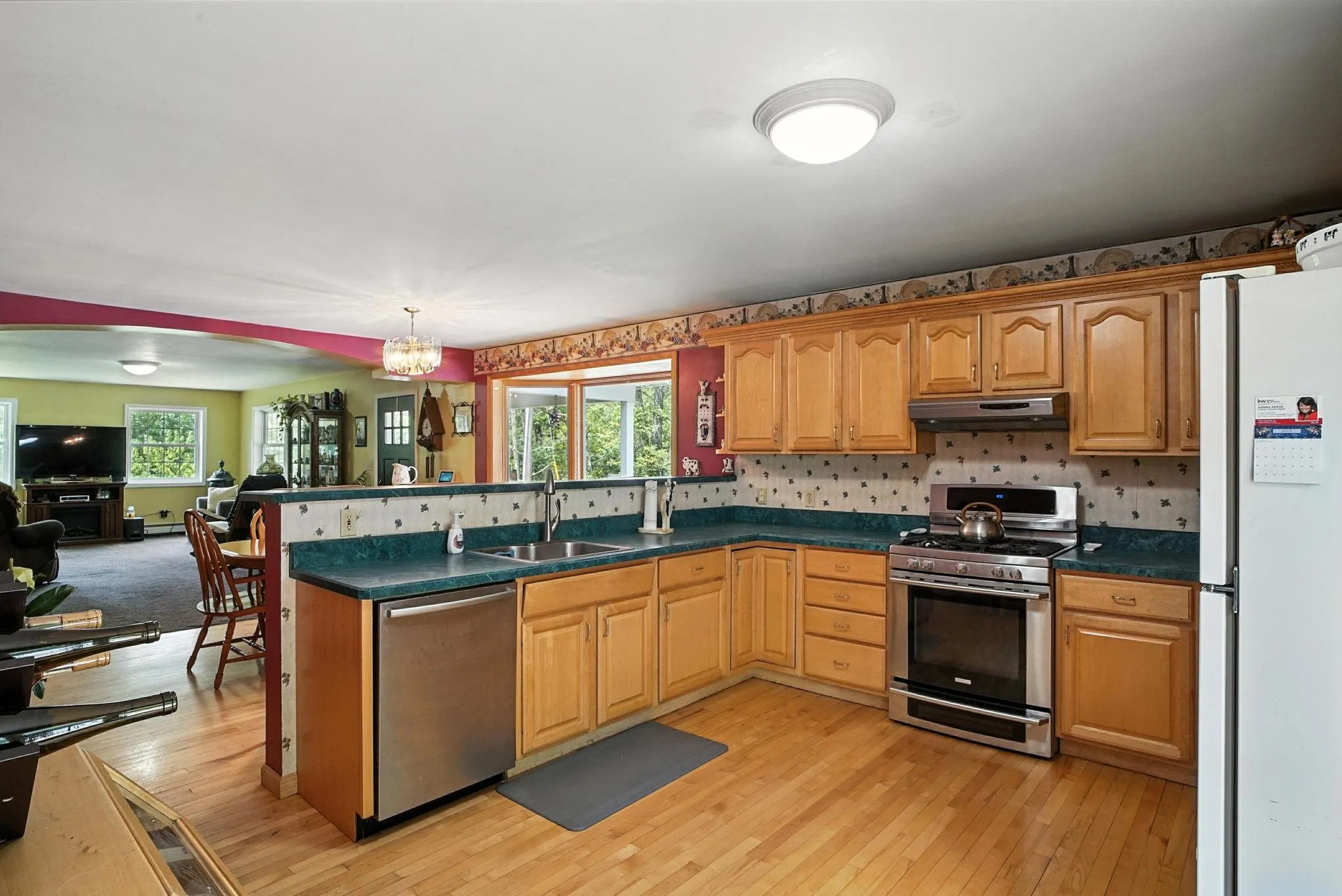 Kitchen with stainless steel appliances, open floor plan, a peninsula, and healthy amount of natural light Kitchen with stainless steel appliances, open floor plan, a peninsula, and healthy amount of natural light