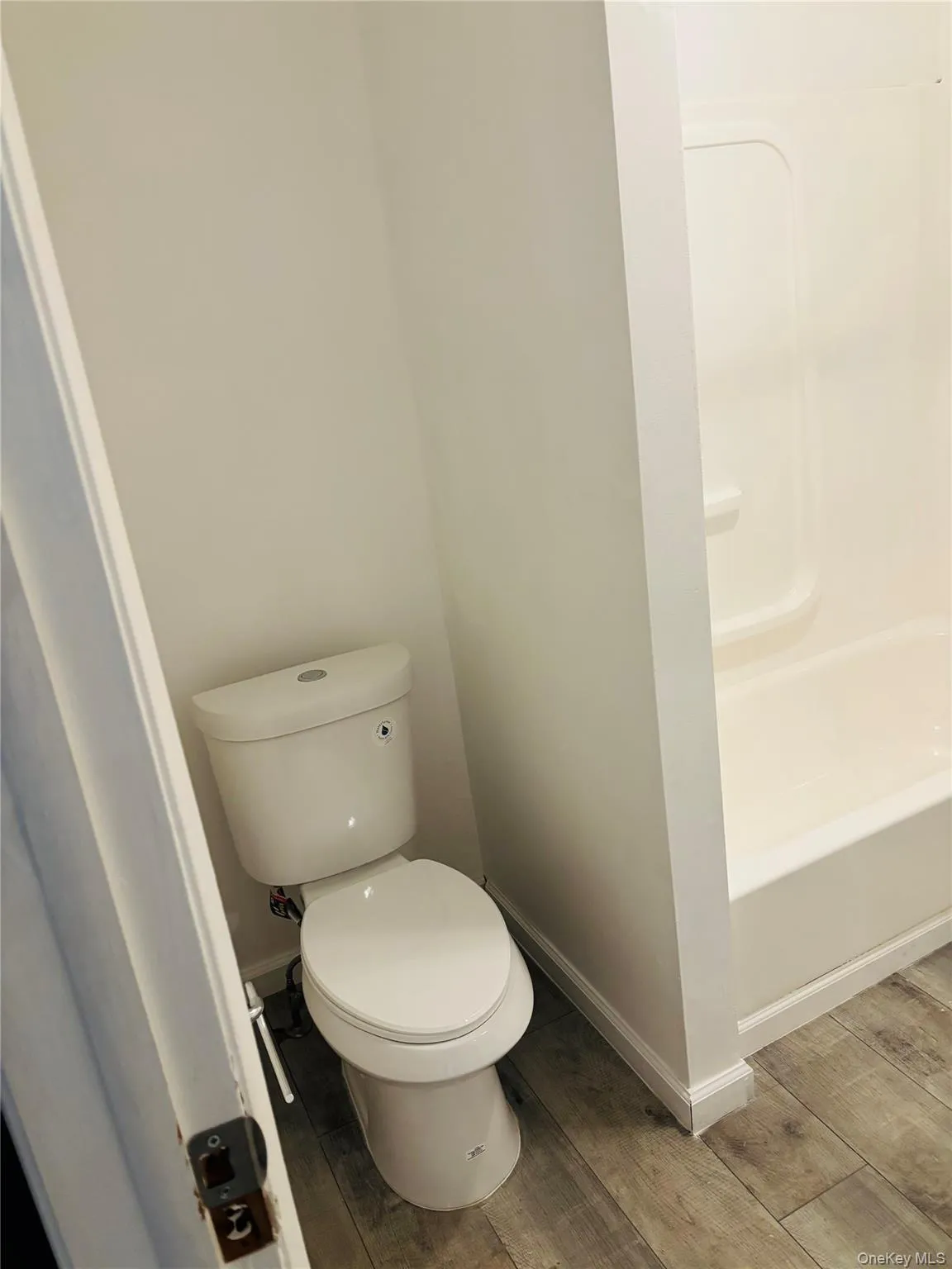 Bathroom with baseboards and wood finish floors Bathroom with baseboards and wood finish floors