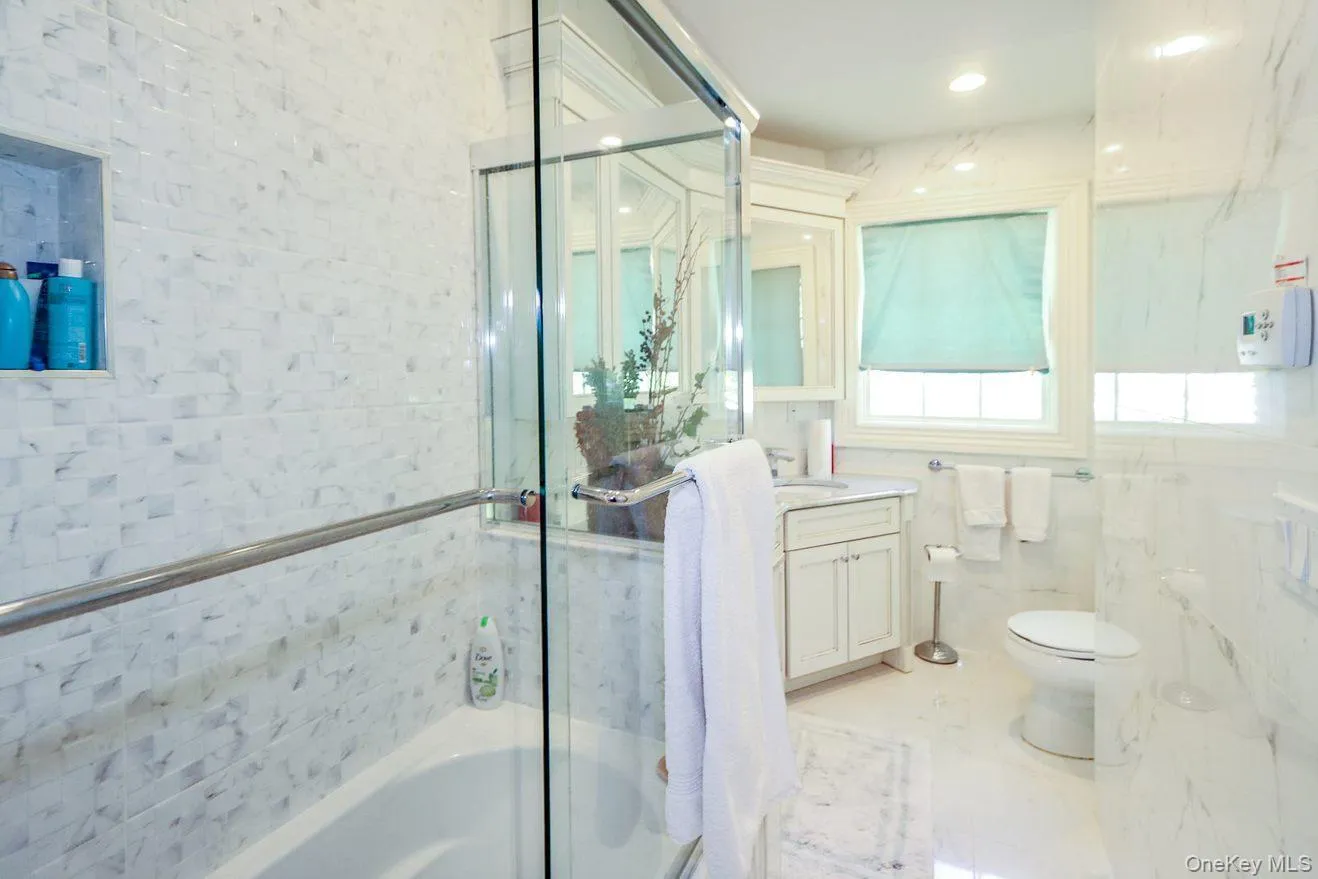 Full bathroom with vanity and bath / shower combo with glass door Full bathroom with vanity and bath / shower combo with glass door