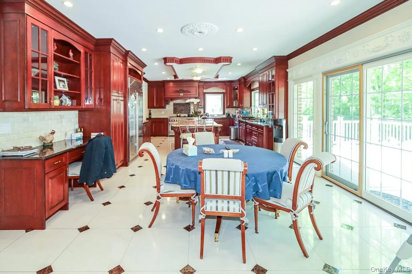 Dining space featuring plenty of natural light, recessed lighting, built in desk, crown molding, and light tile patterned floors Dining space featuring plenty of natural light, recessed lighting, built in desk, crown molding, and light tile patterned floors