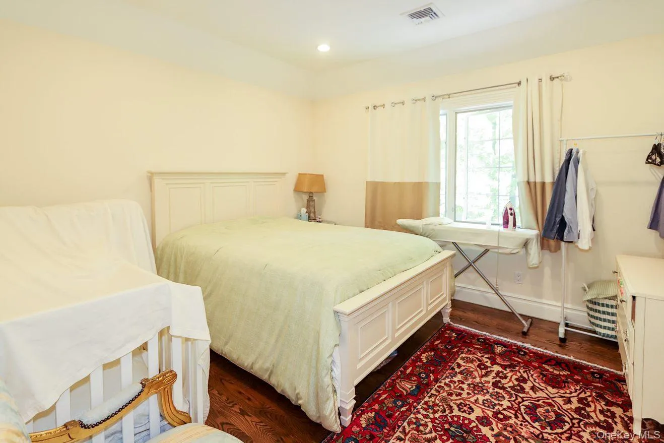 Bedroom with dark wood-style floors and baseboards Bedroom with dark wood-style floors and baseboards