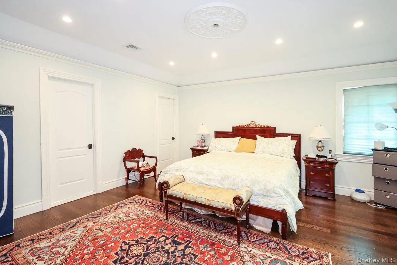 Bedroom featuring wood finished floors, recessed lighting, and crown molding Bedroom featuring wood finished floors, recessed lighting, and crown molding