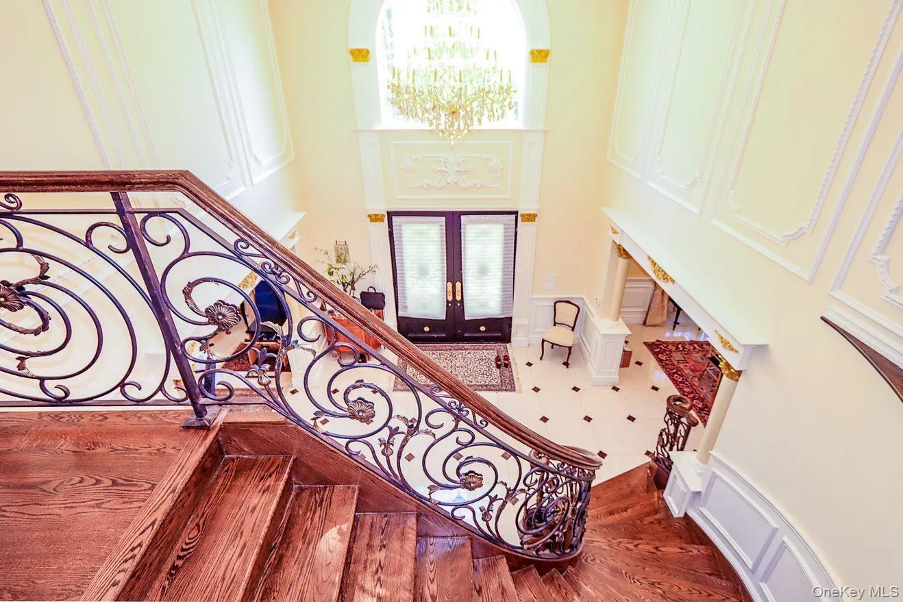 Entryway featuring french doors, stairs, a chandelier, a towering ceiling, and plenty of natural light Entryway featuring french doors, stairs, a chandelier, a towering ceiling, and plenty of natural light