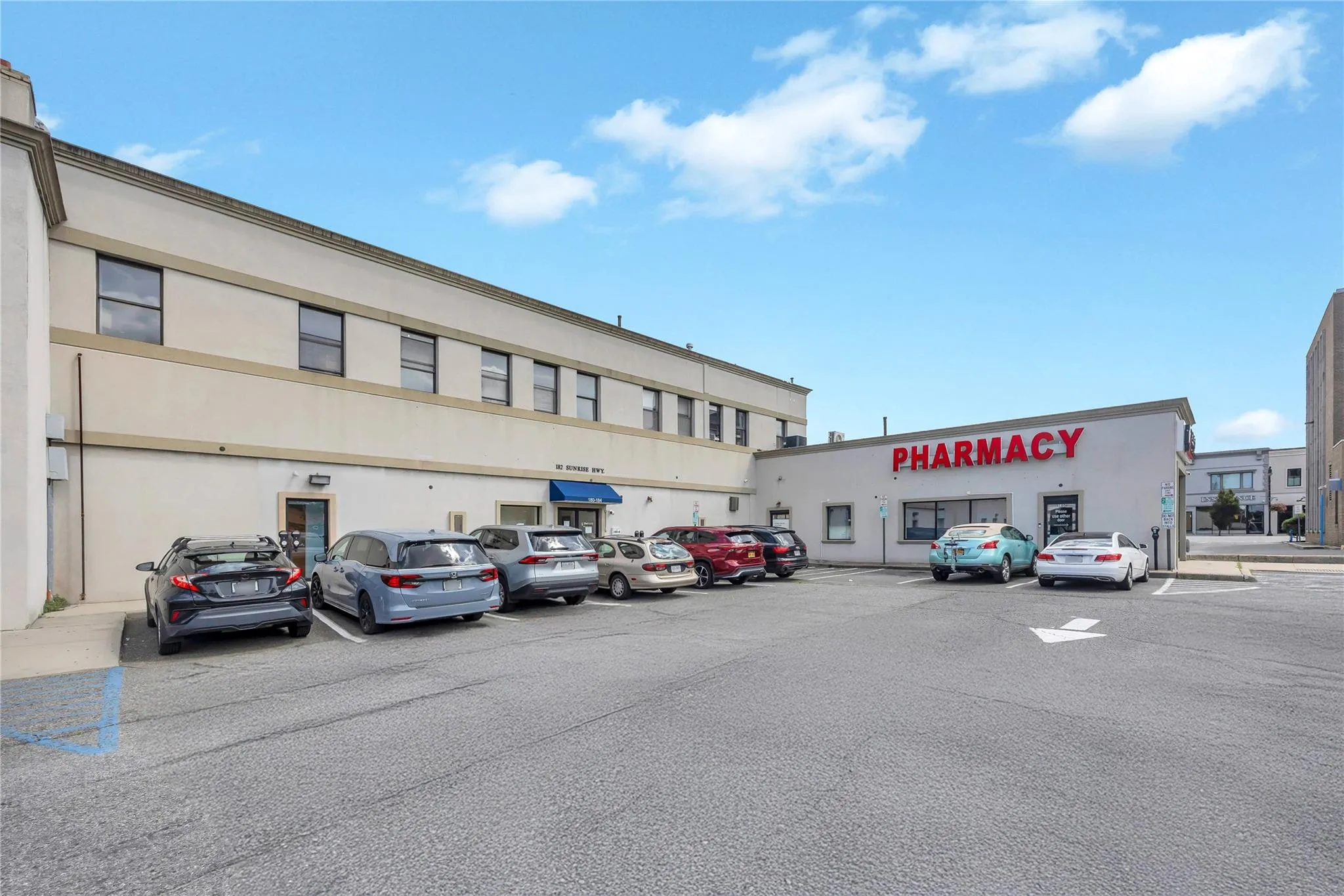 View of commercial property featuring uncovered parking View of commercial property featuring uncovered parking