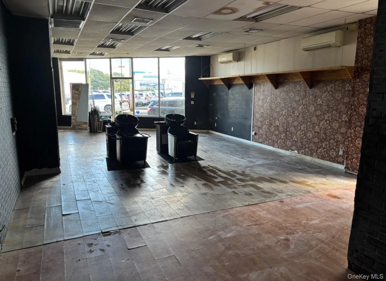 Community lobby featuring wallpapered walls and a drop ceiling Community lobby featuring wallpapered walls and a drop ceiling