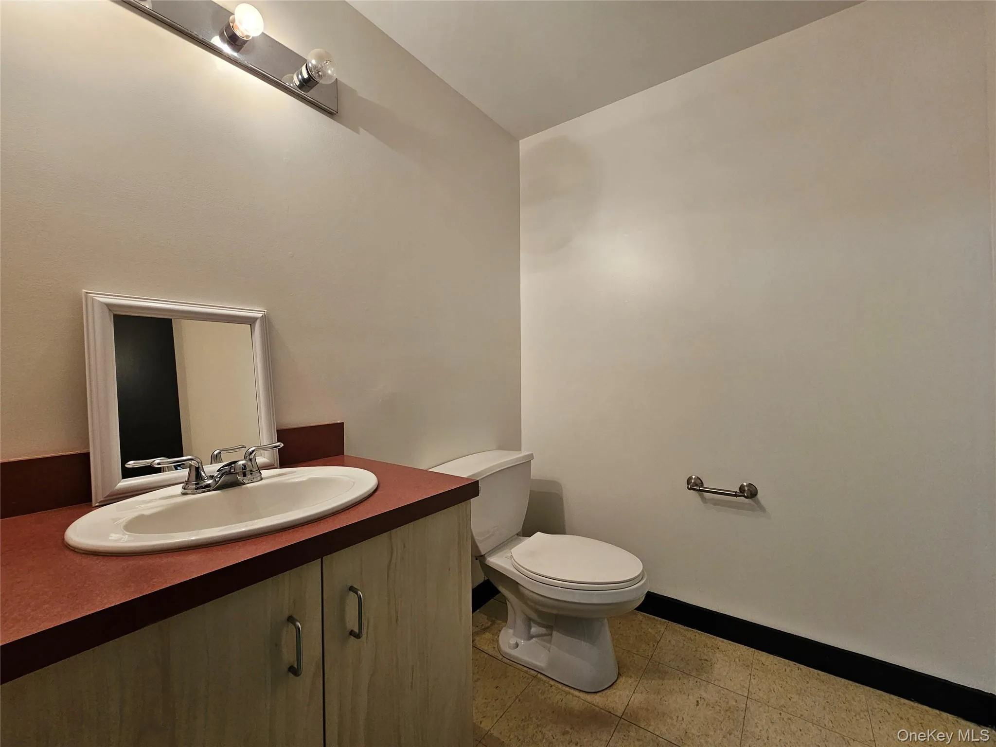 Bathroom featuring vanity and baseboards Bathroom featuring vanity and baseboards