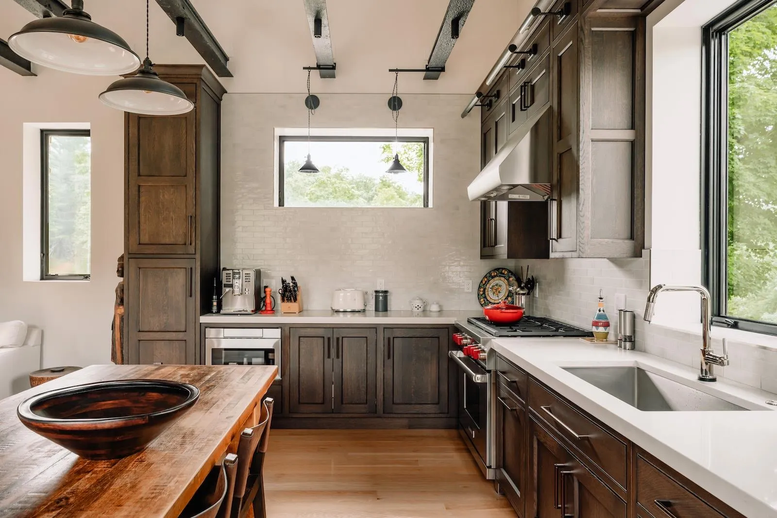 Kitchen featuring stainless steel range, butcher block countertops, tasteful backsplash, light wood-style floors, and pendant lighting Kitchen featuring stainless steel range, butcher block countertops, tasteful backsplash, light wood-style floors, and pendant lighting