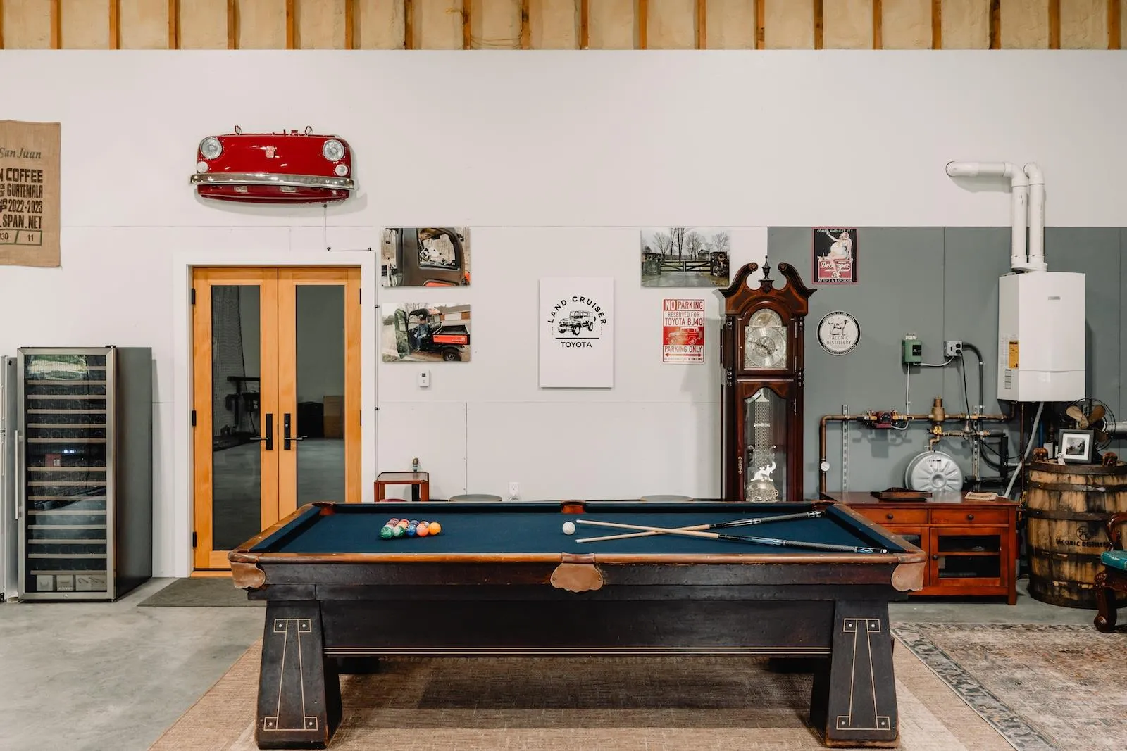 Recreation room with billiards, concrete flooring, beverage cooler, water heater, and french doors Recreation room with billiards, concrete flooring, beverage cooler, water heater, and french doors
