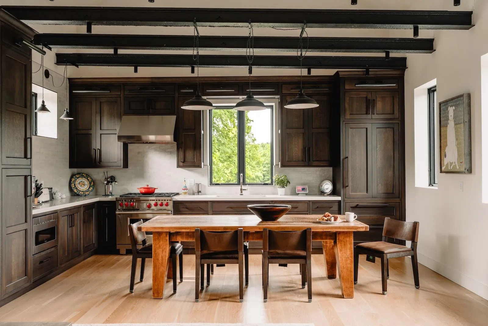 Kitchen featuring light wood finished floors, light countertops, range hood, backsplash, and beam ceiling Kitchen featuring light wood finished floors, light countertops, range hood, backsplash, and beam ceiling