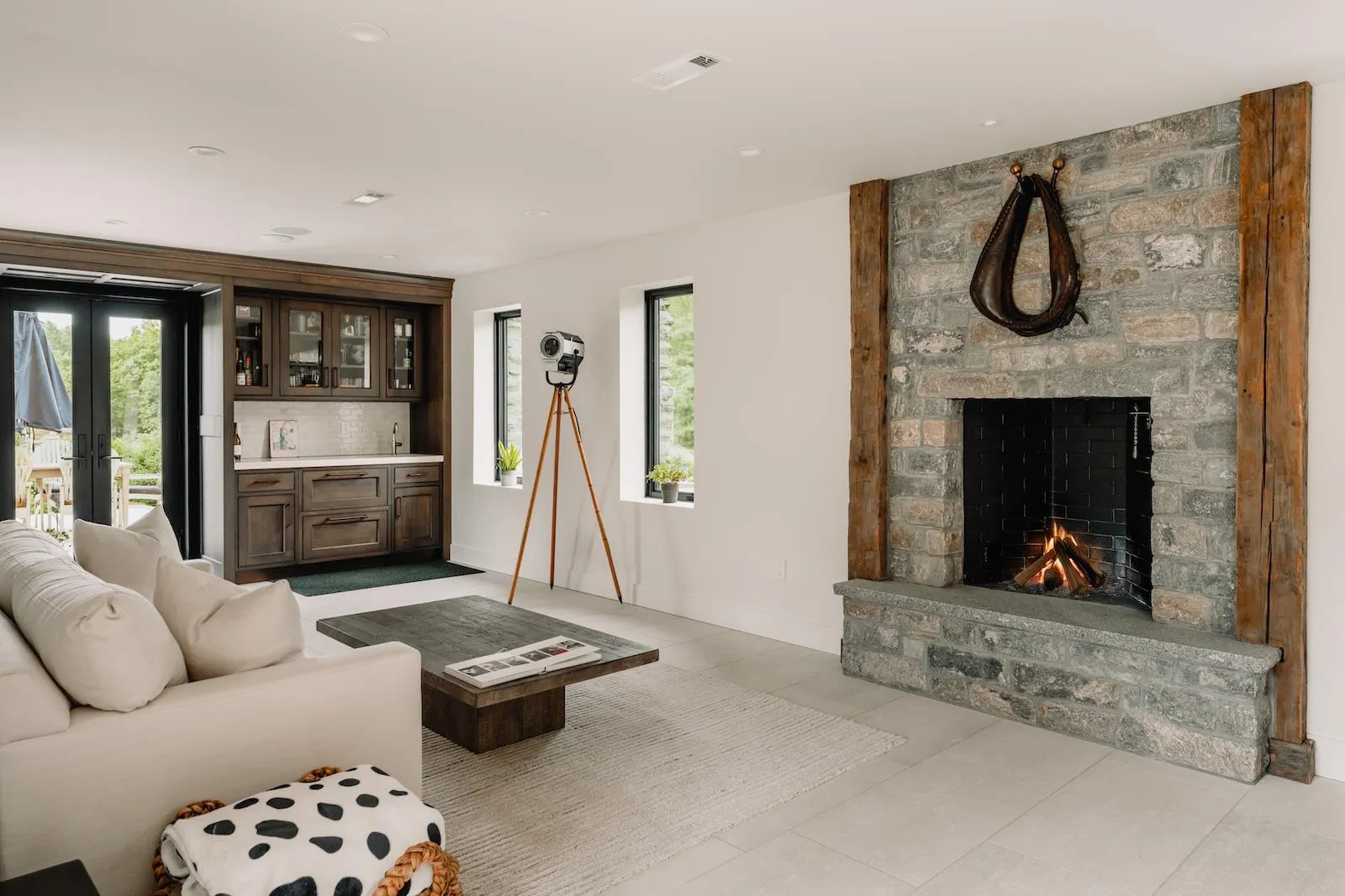 Living area with plenty of natural light, a fireplace, and light tile patterned floors Living area with plenty of natural light, a fireplace, and light tile patterned floors