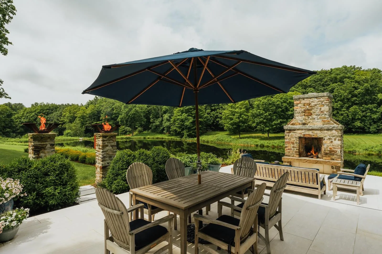 View of patio / terrace featuring an outdoor stone fireplace and outdoor dining space View of patio / terrace featuring an outdoor stone fireplace and outdoor dining space