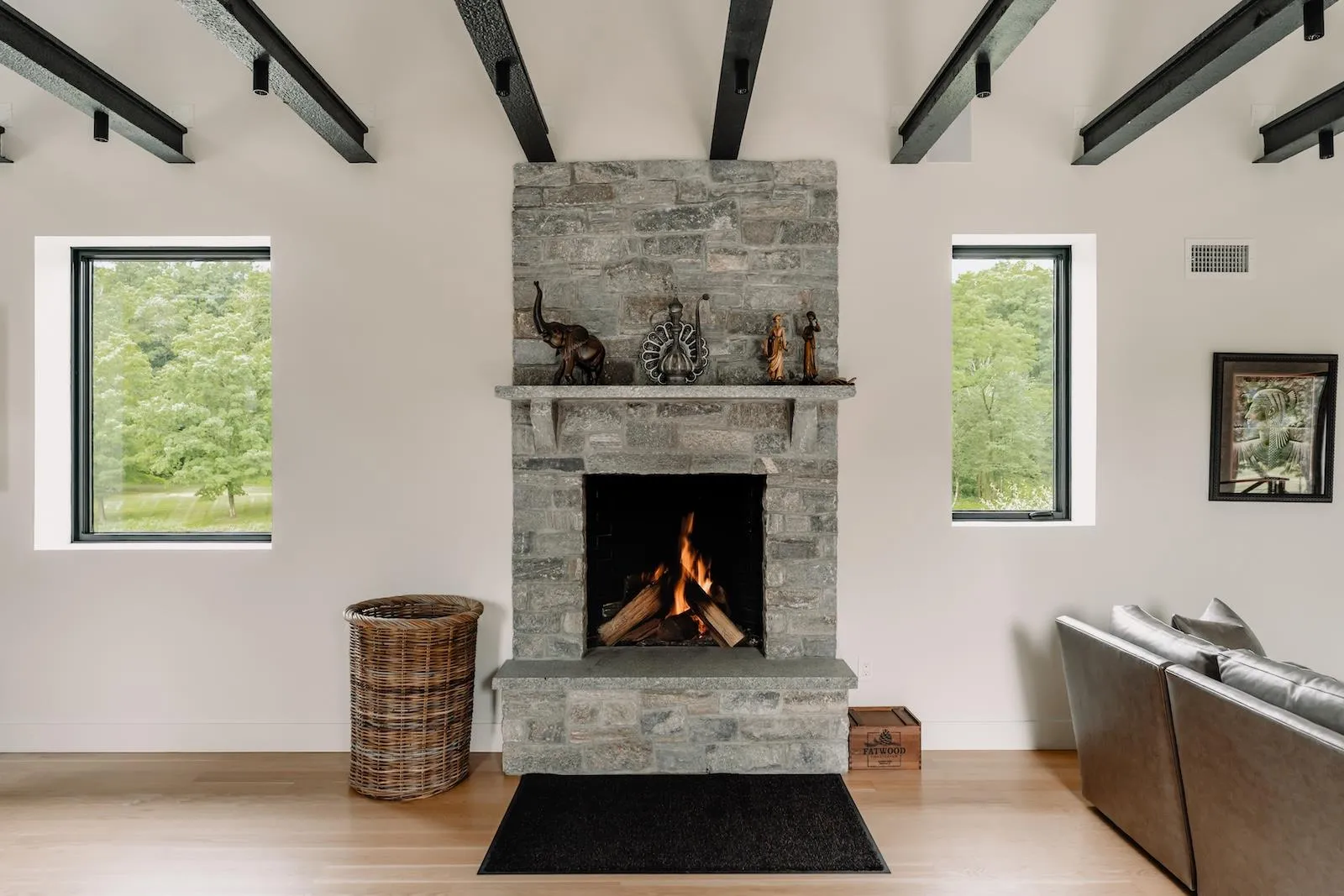 Living area with beamed ceiling, wood finished floors, and a fireplace Living area with beamed ceiling, wood finished floors, and a fireplace