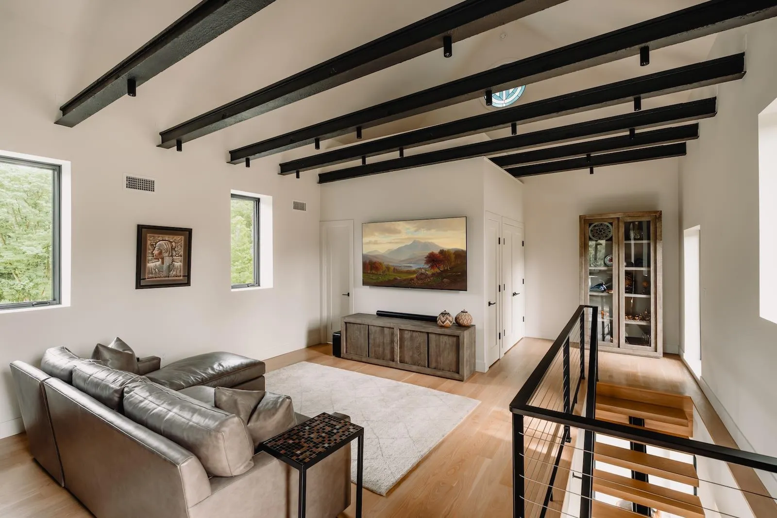 Living area featuring light wood-style flooring and beamed ceiling Living area featuring light wood-style flooring and beamed ceiling