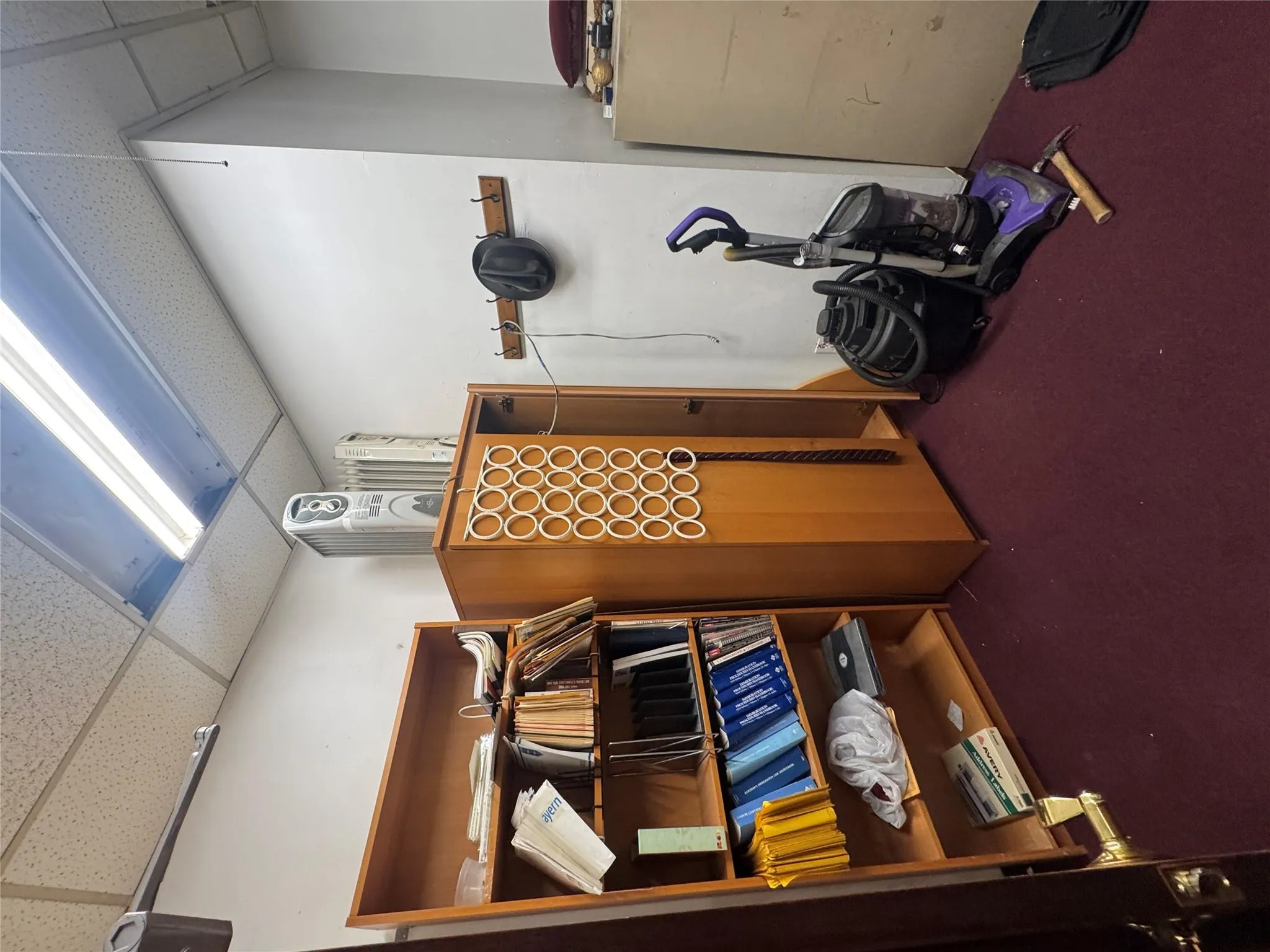 Miscellaneous room featuring a paneled ceiling and carpet floors Miscellaneous room featuring a paneled ceiling and carpet floors