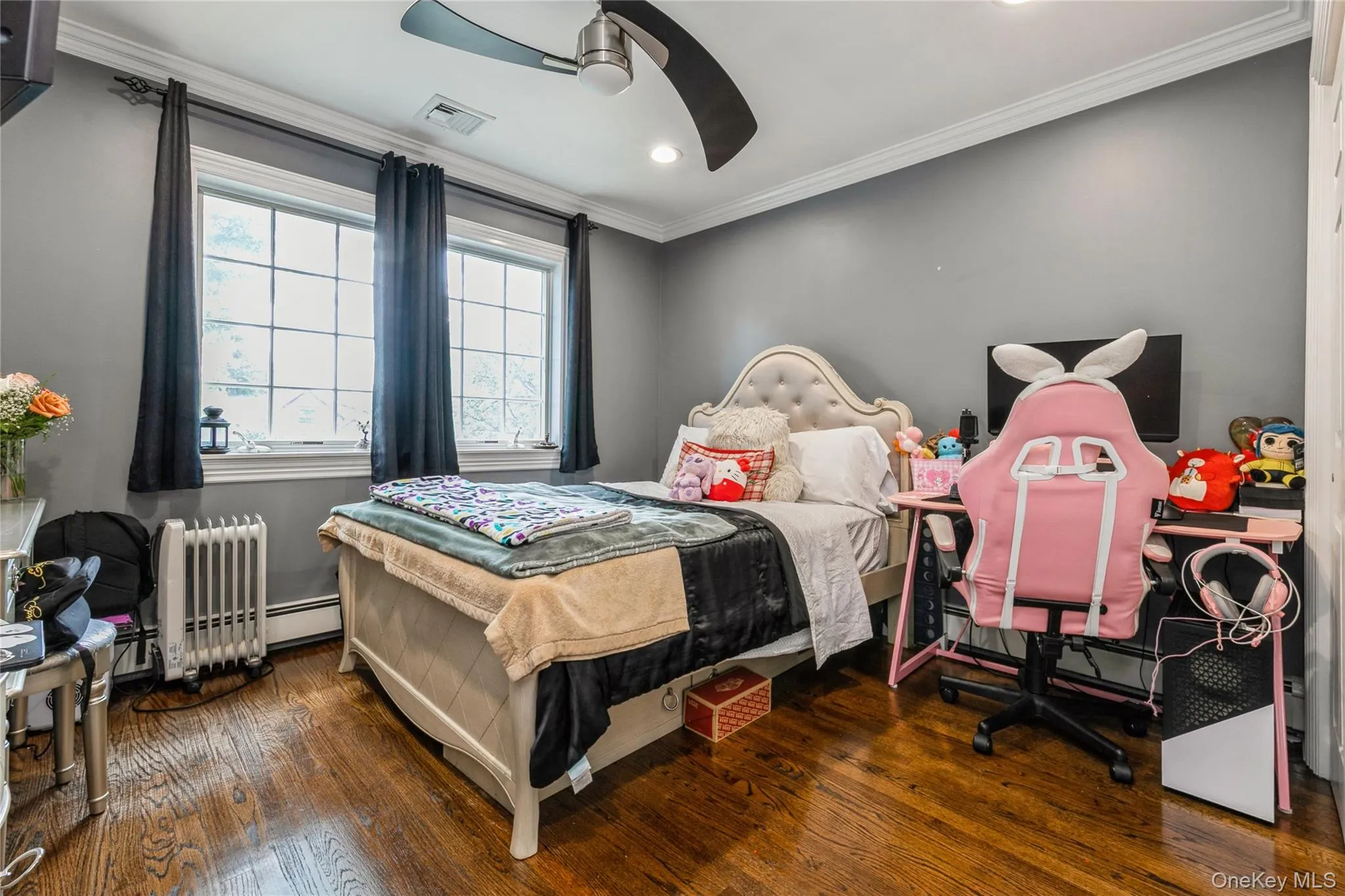 Bedroom featuring wood finished floors, ornamental molding, recessed lighting, a ceiling fan, and radiator Bedroom featuring wood finished floors, ornamental molding, recessed lighting, a ceiling fan, and radiator