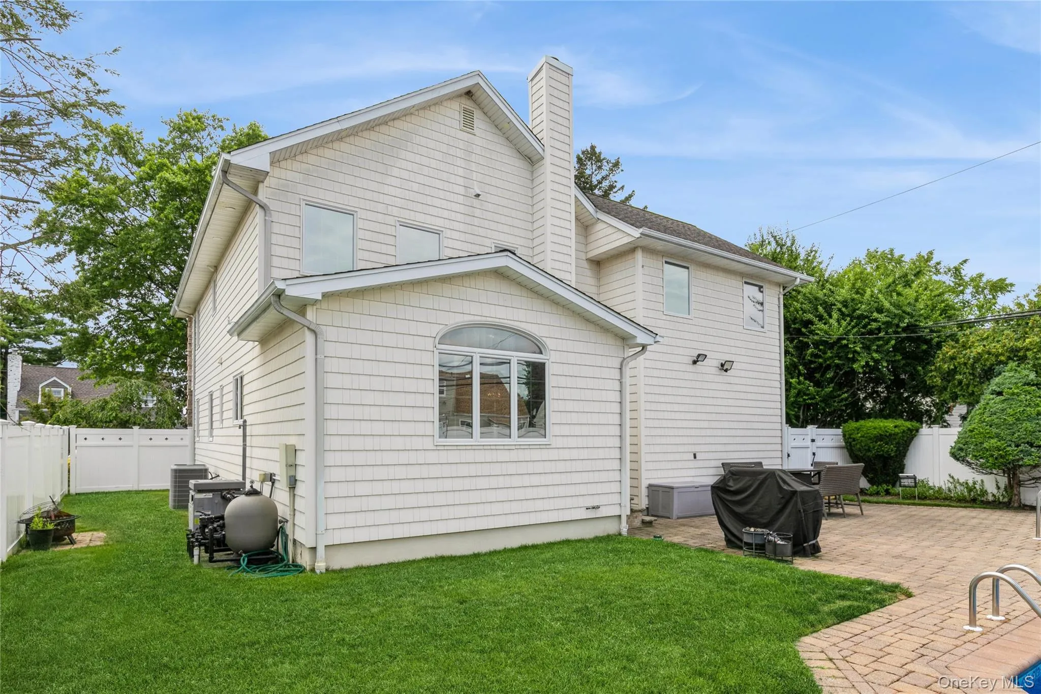 Back of property with a patio area, a fenced backyard, and a chimney Back of property with a patio area, a fenced backyard, and a chimney