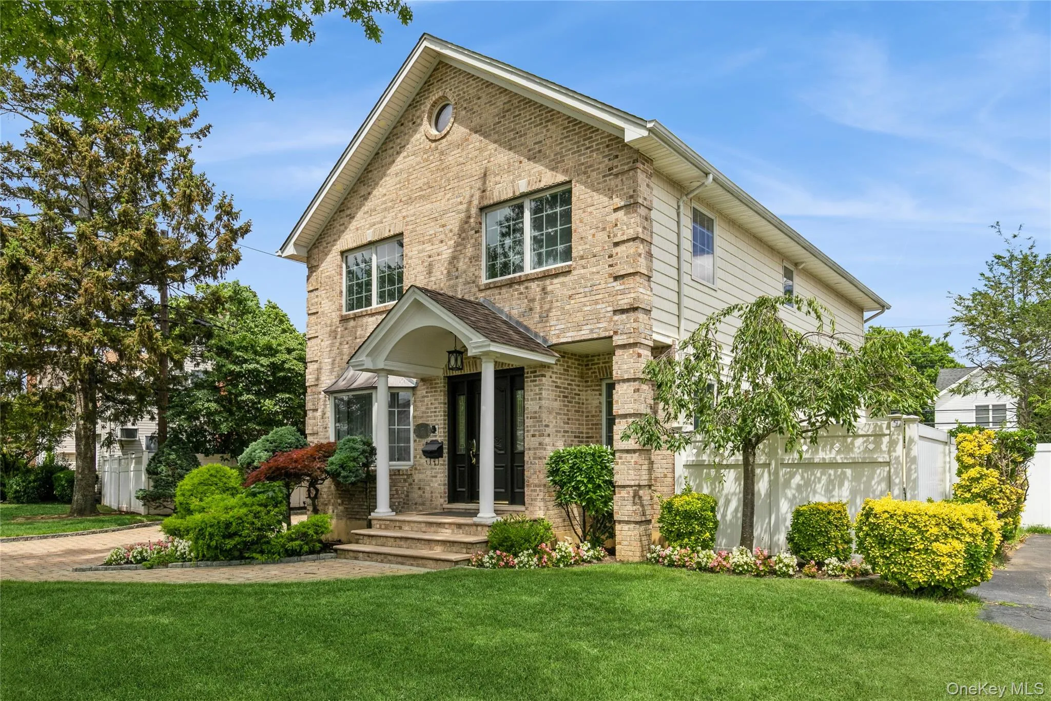 View of front of house featuring brick siding and a front lawn View of front of house featuring brick siding and a front lawn