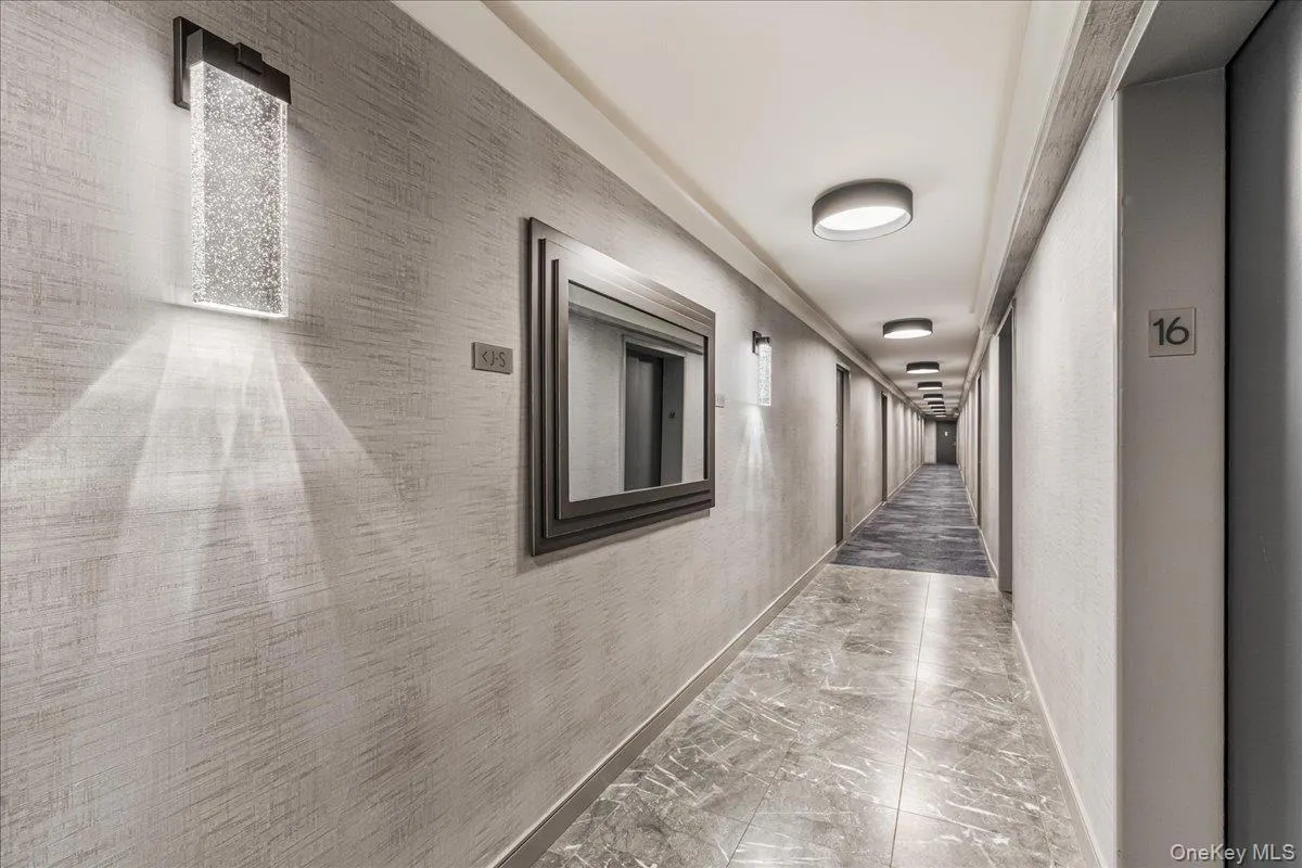 Corridor with marble finish floors and baseboards Corridor with marble finish floors and baseboards