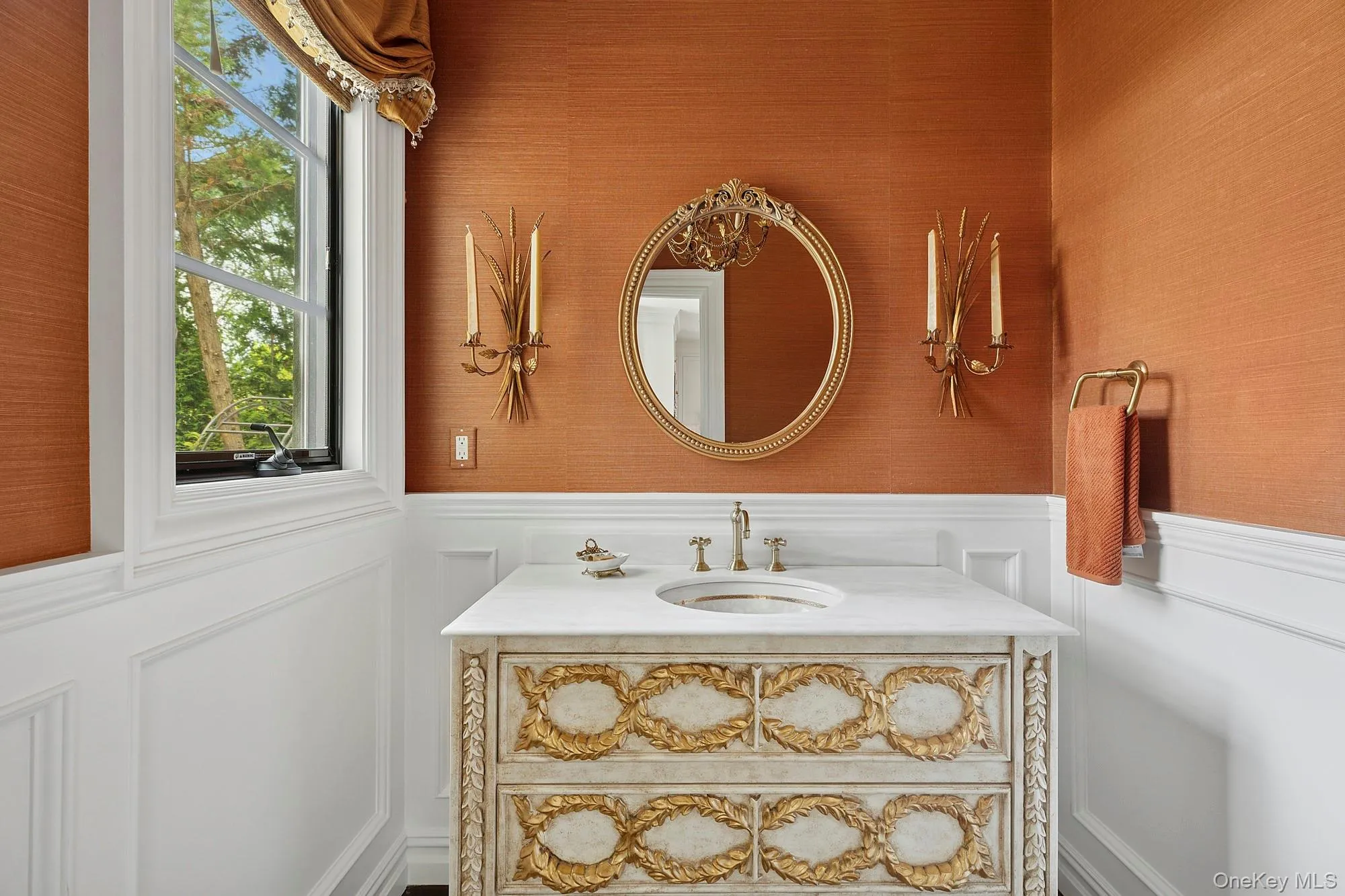Bathroom featuring a decorative wall, a wainscoted wall, and vanity Bathroom featuring a decorative wall, a wainscoted wall, and vanity