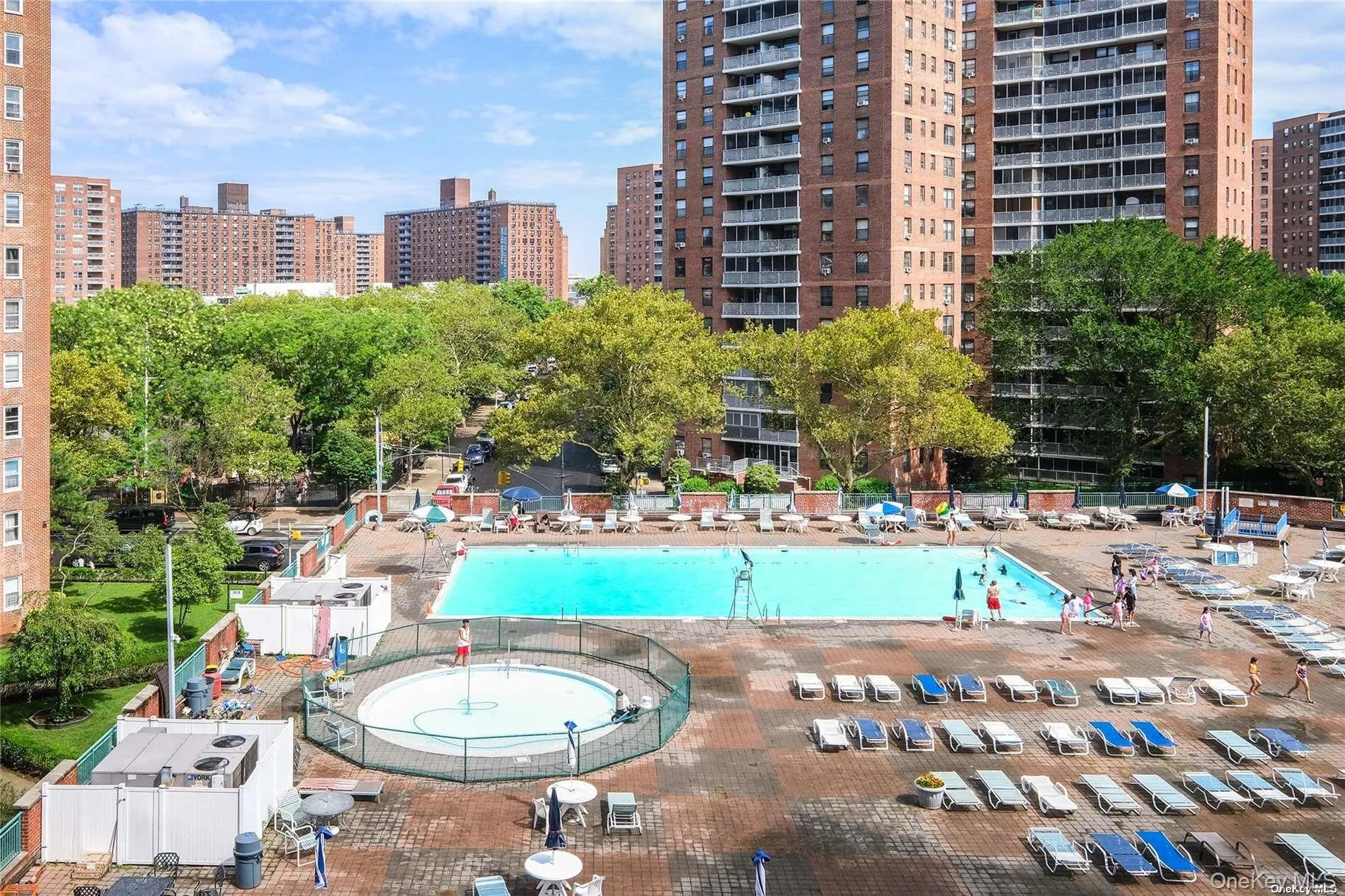 Community pool with a city view and a patio Community pool with a city view and a patio