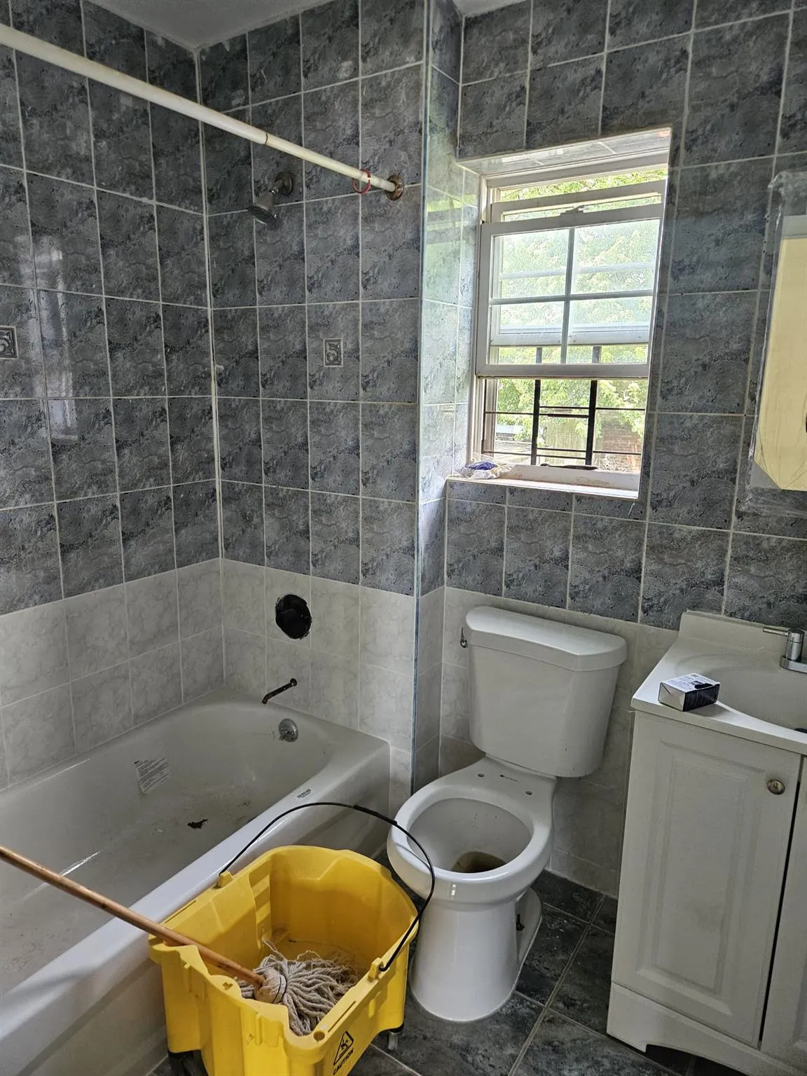 Bathroom with bathing tub / shower combination, tile walls, and vanity Bathroom with bathing tub / shower combination, tile walls, and vanity