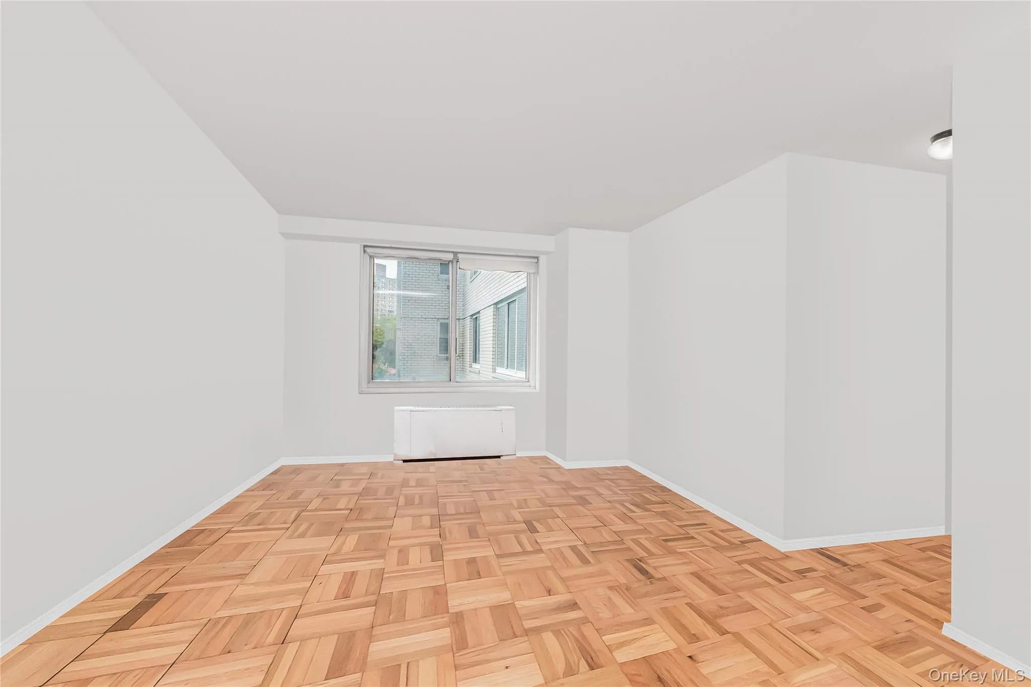 Spare room with radiator and baseboards Spare room with radiator and baseboards