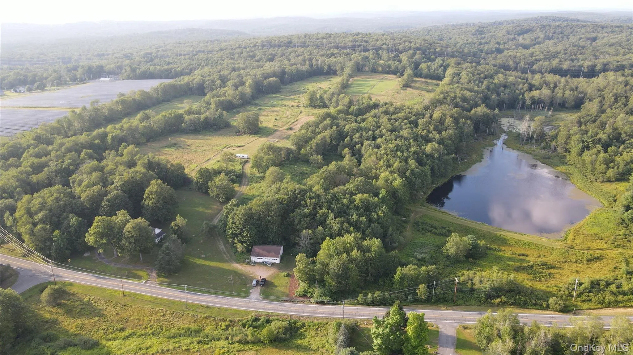 View of property location featuring a large body of water and a forest View of property location featuring a large body of water and a forest