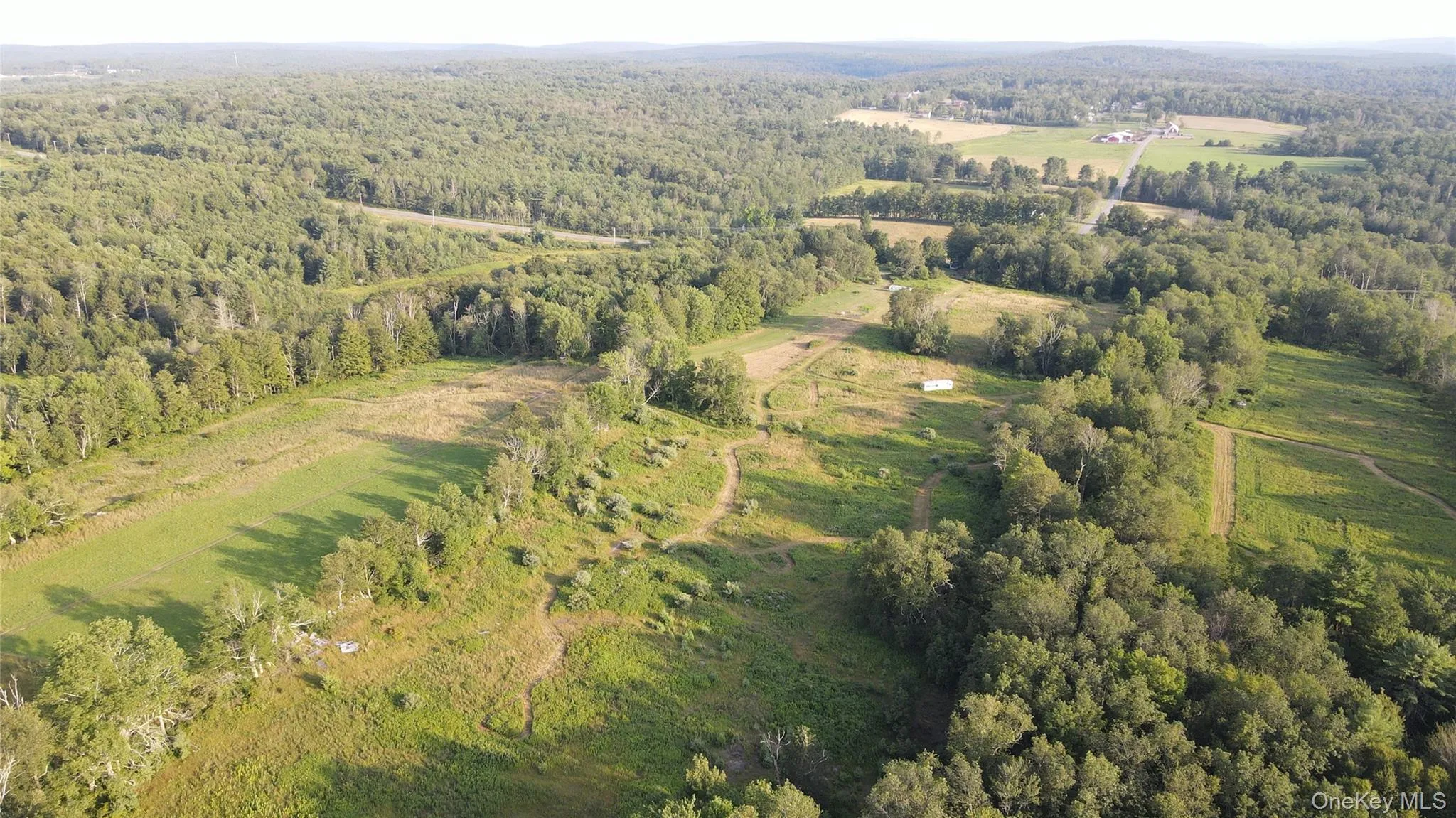 View of property location with a heavily wooded area View of property location with a heavily wooded area