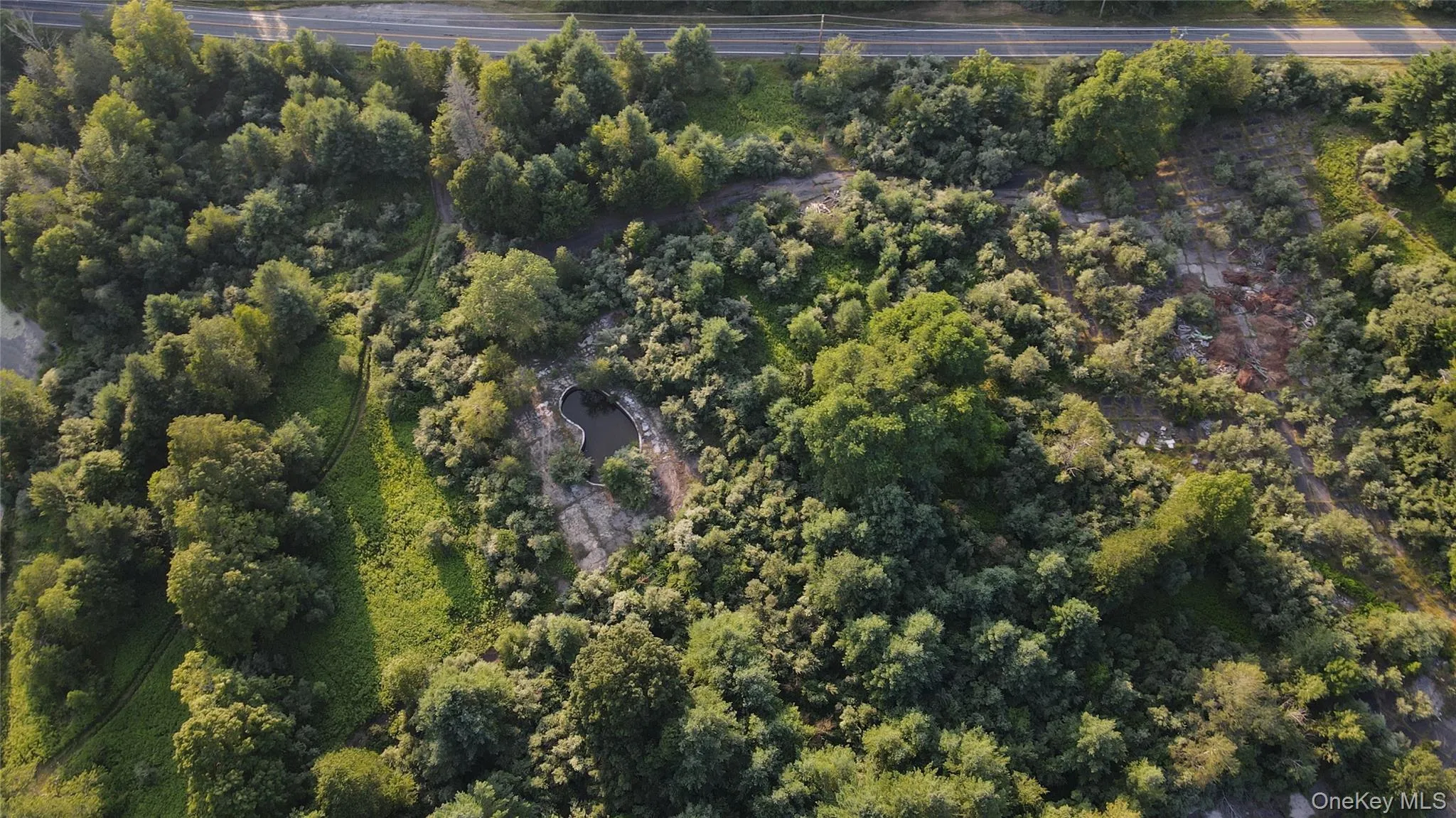 Aerial view of property's location with a heavily wooded area Aerial view of property's location with a heavily wooded area
