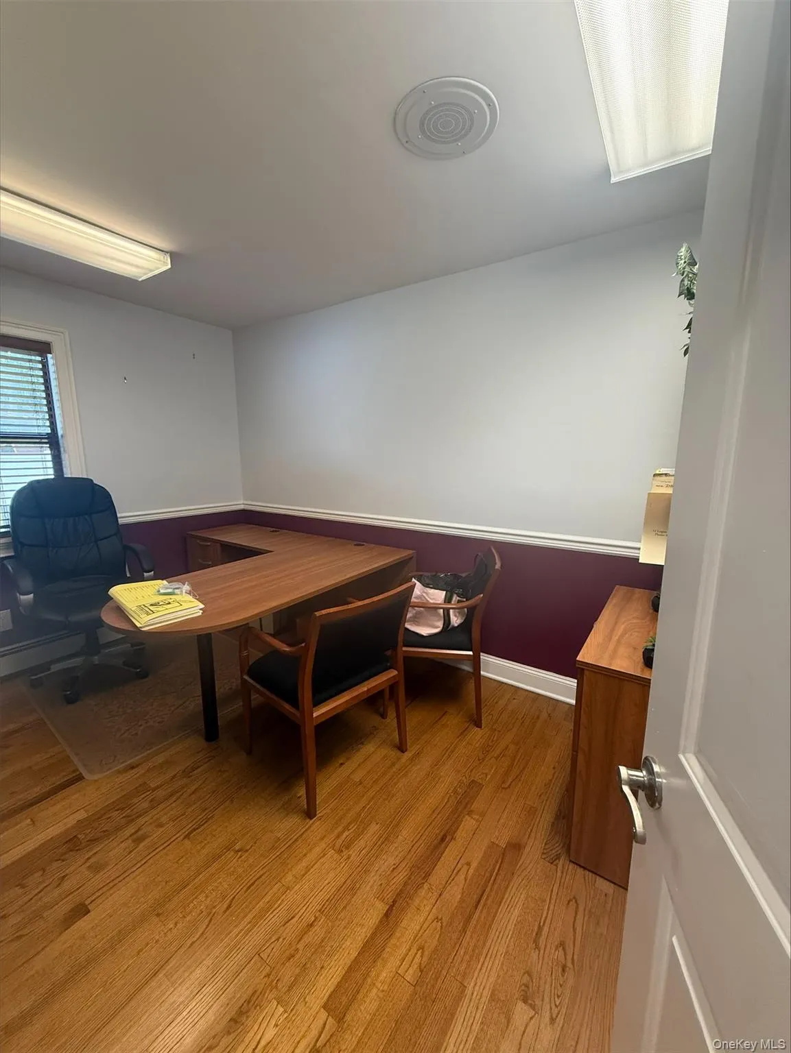 Home office with light wood-type flooring Home office with light wood-type flooring